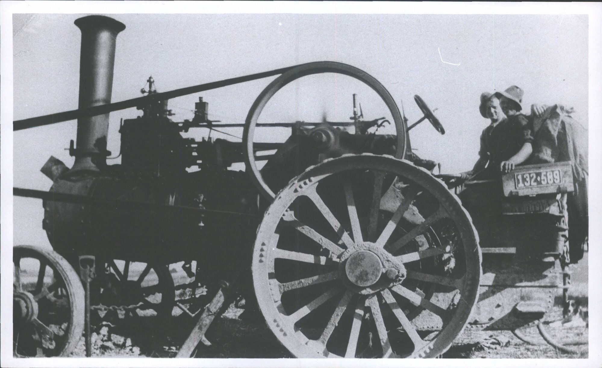 Tractor engine driving a wooden mill