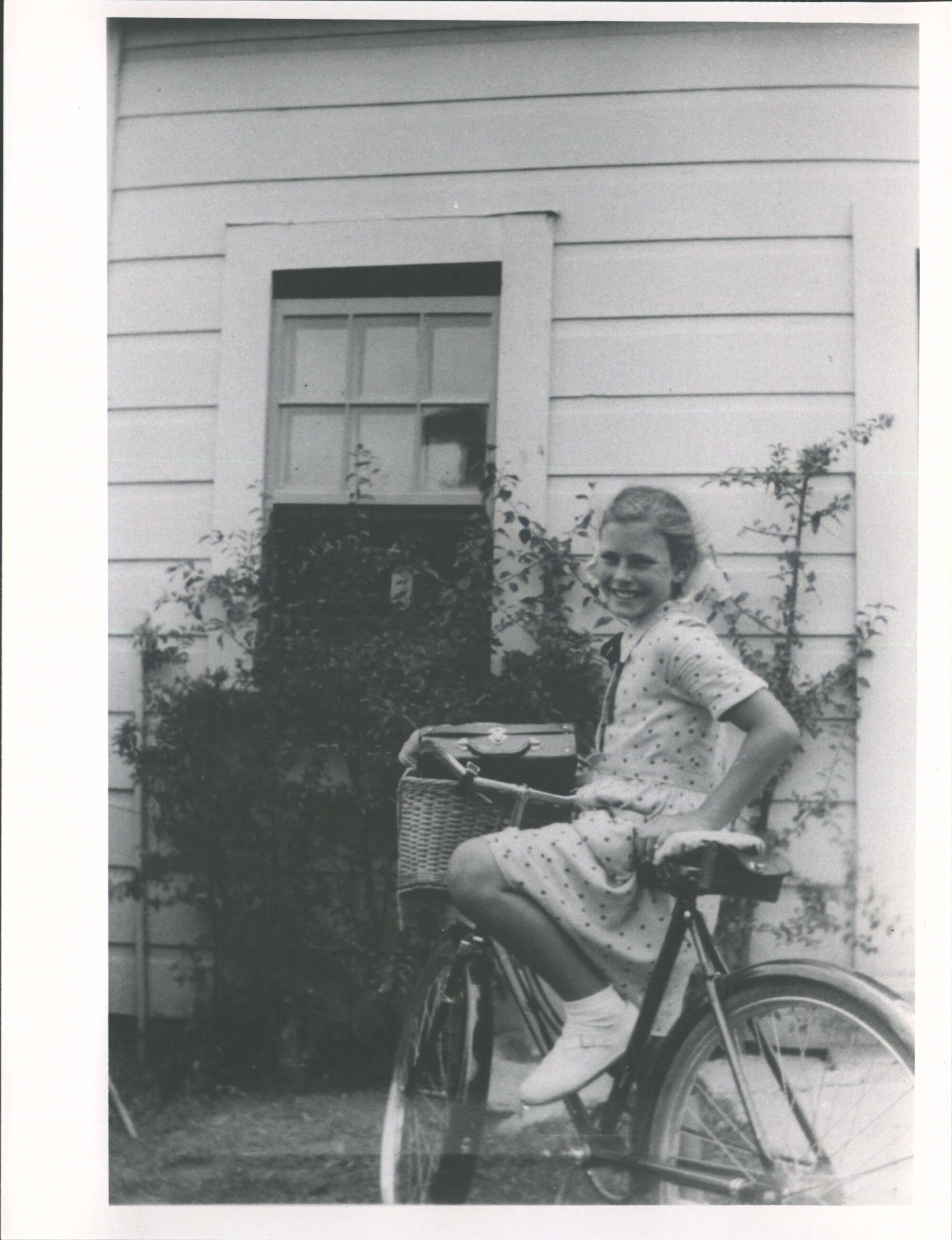 Raylene by washhouse window, Mangaweka, 1952