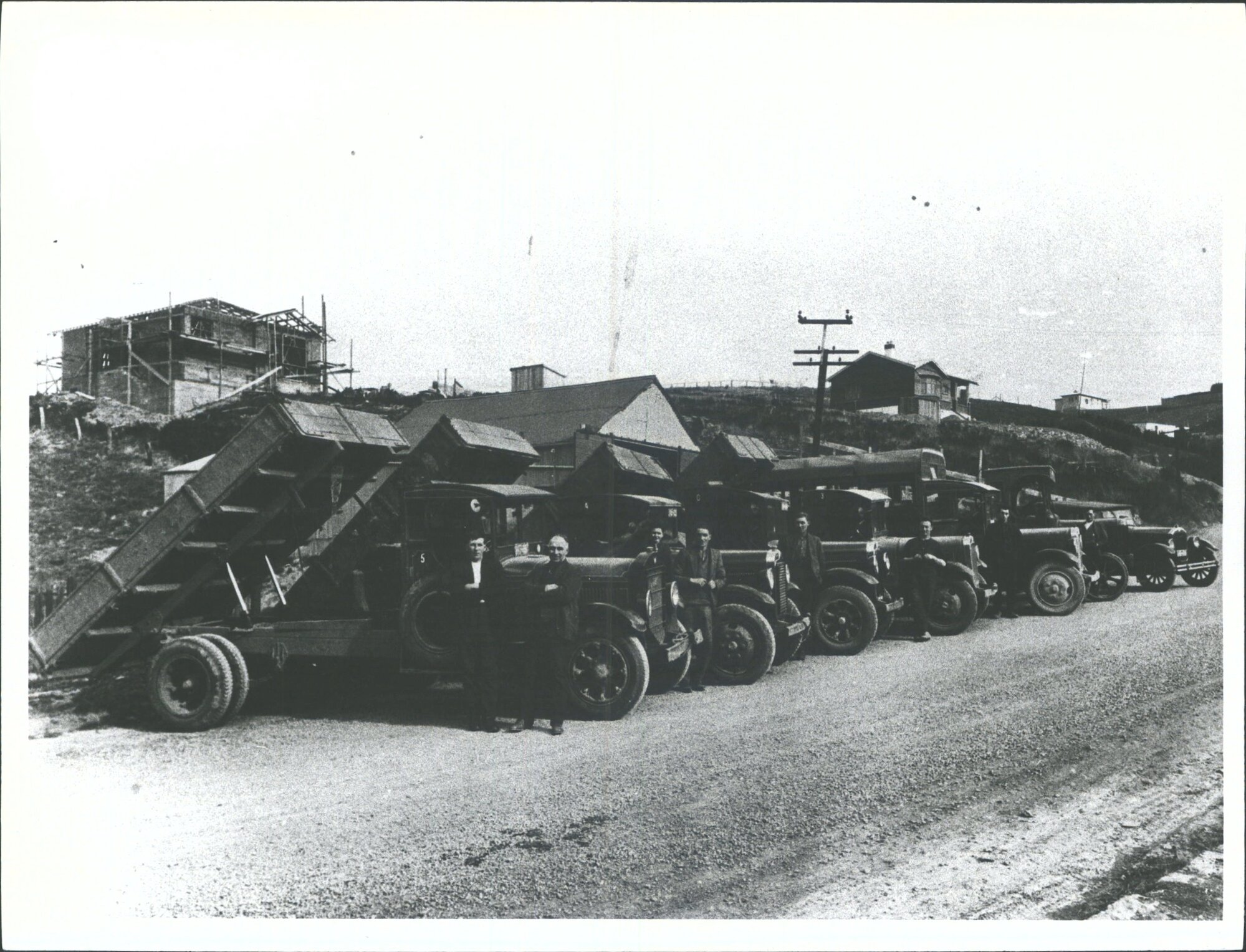 Harry McKay with fleet of trucks