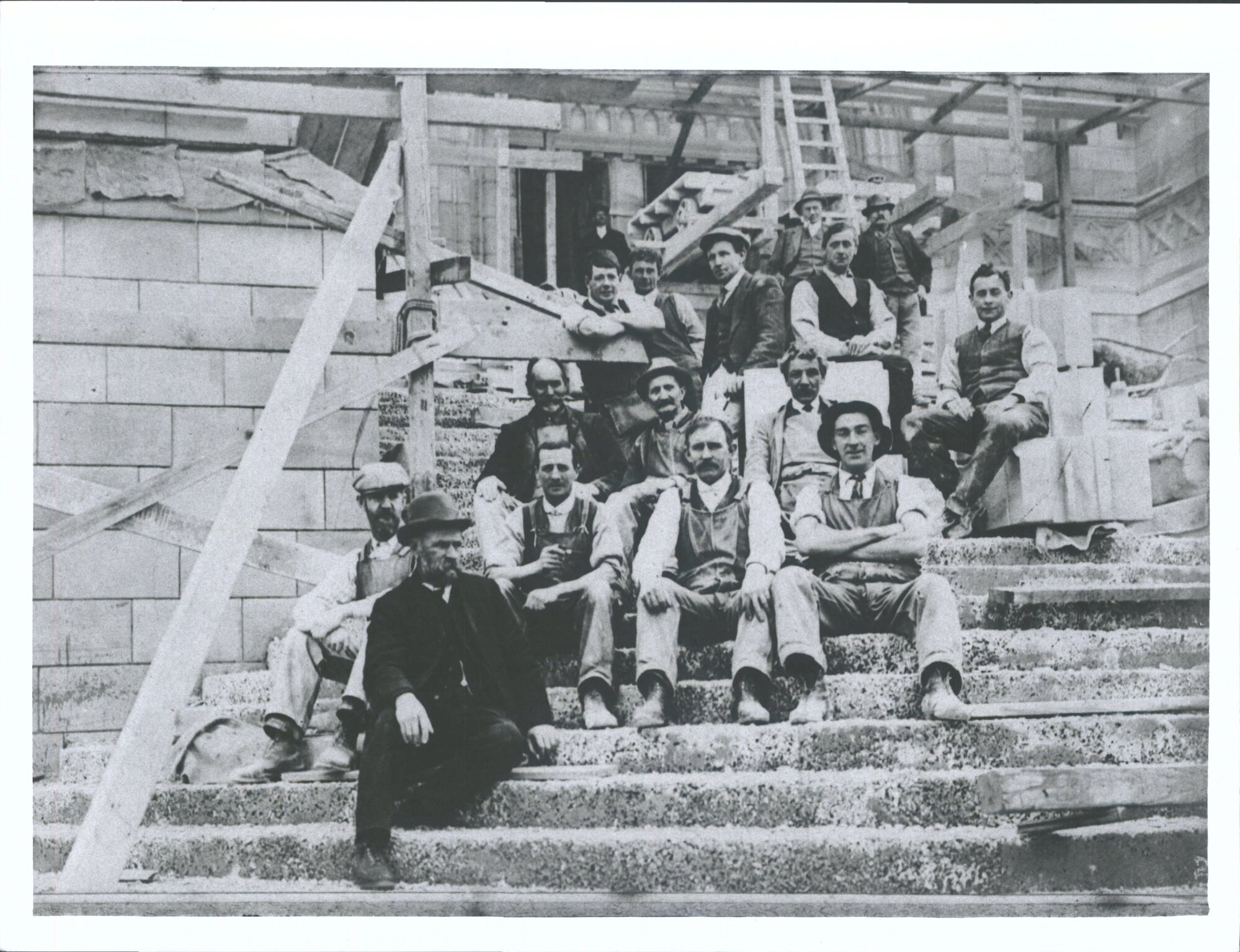 Construction, Mar[r] &amp; McLeod plasterers working on building George Callister on steps near top in waist coat &amp; white shirt