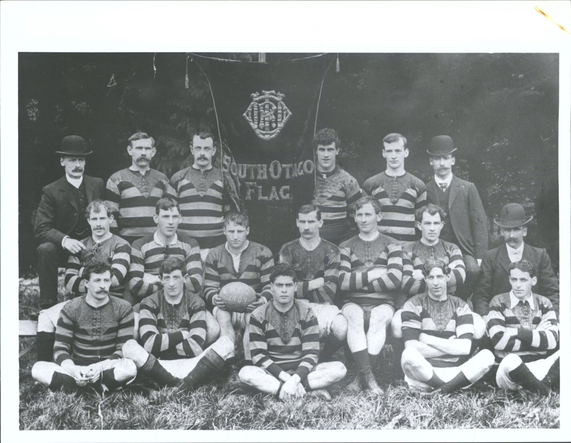 Rugby Football Team, Banner Winners 1909    "Front: J. McAuley, J. Penman, H. Murphy, J. Mills, T. Sharp. Sitting: W. Hughes, J.