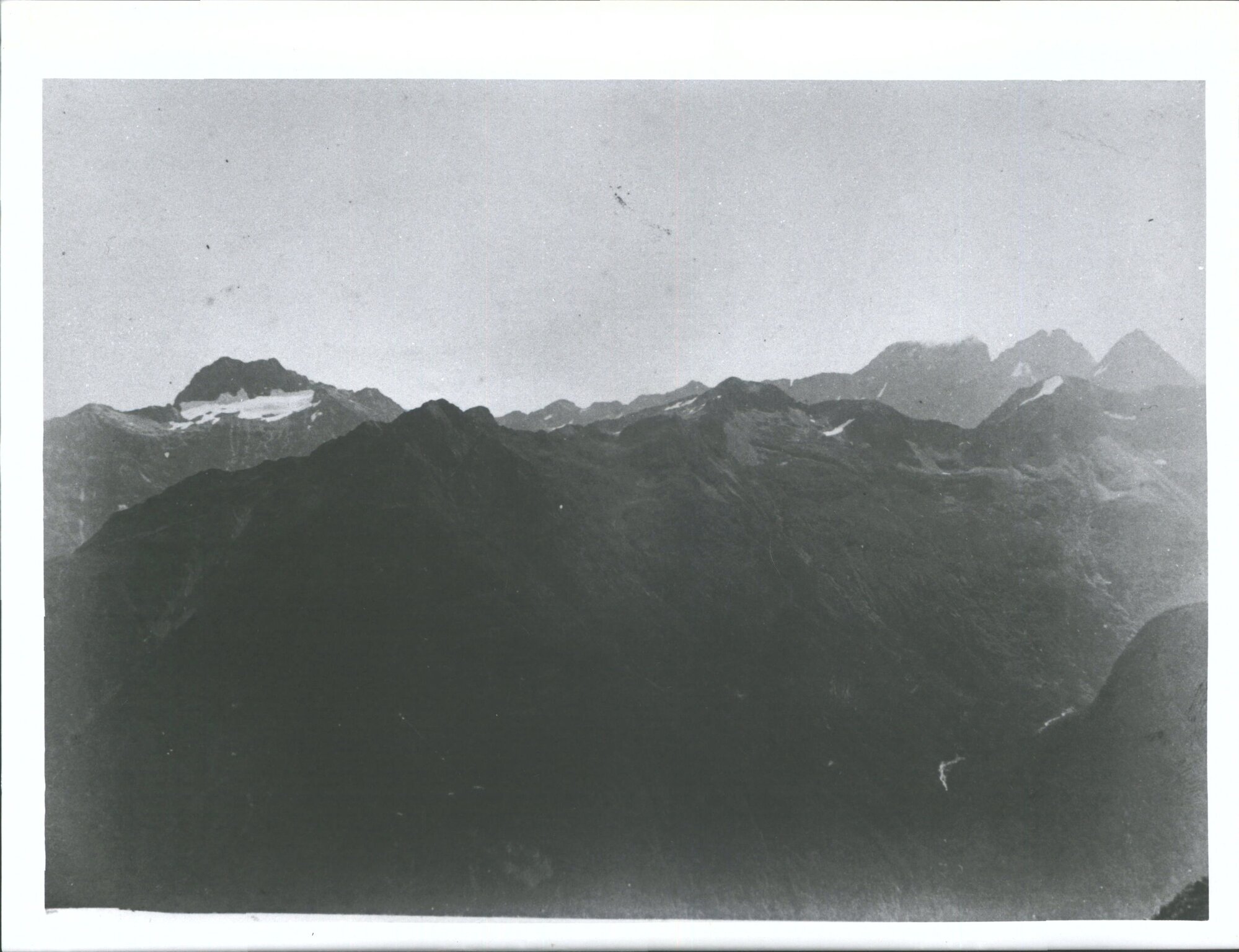 "Looking west from Summit of Livingstone Range about 1 1/2 miles South of Lake McKellar - Mt. Anau is in background on left of v