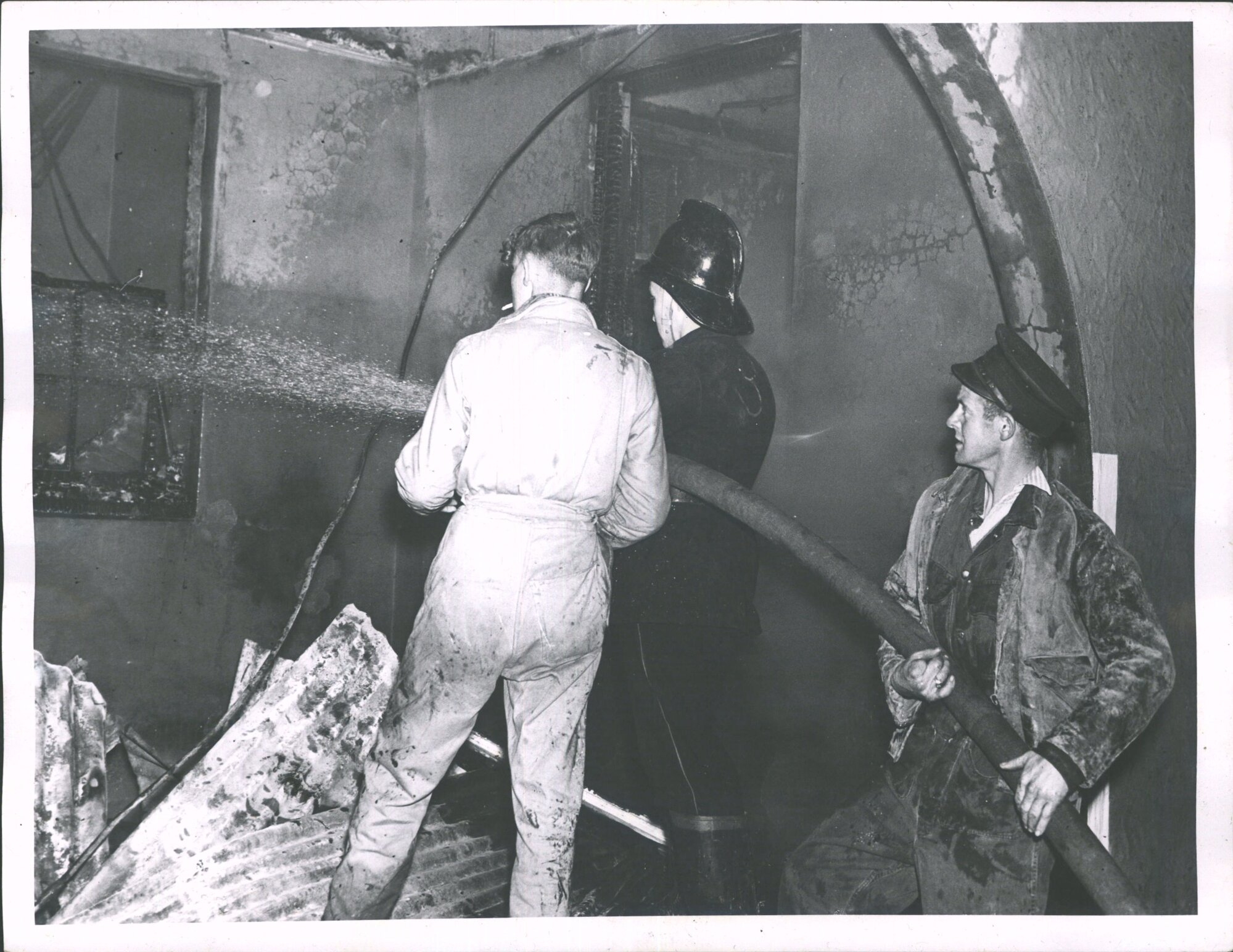 HANMER LODGE FIRE - Firemen training water on glowing embers