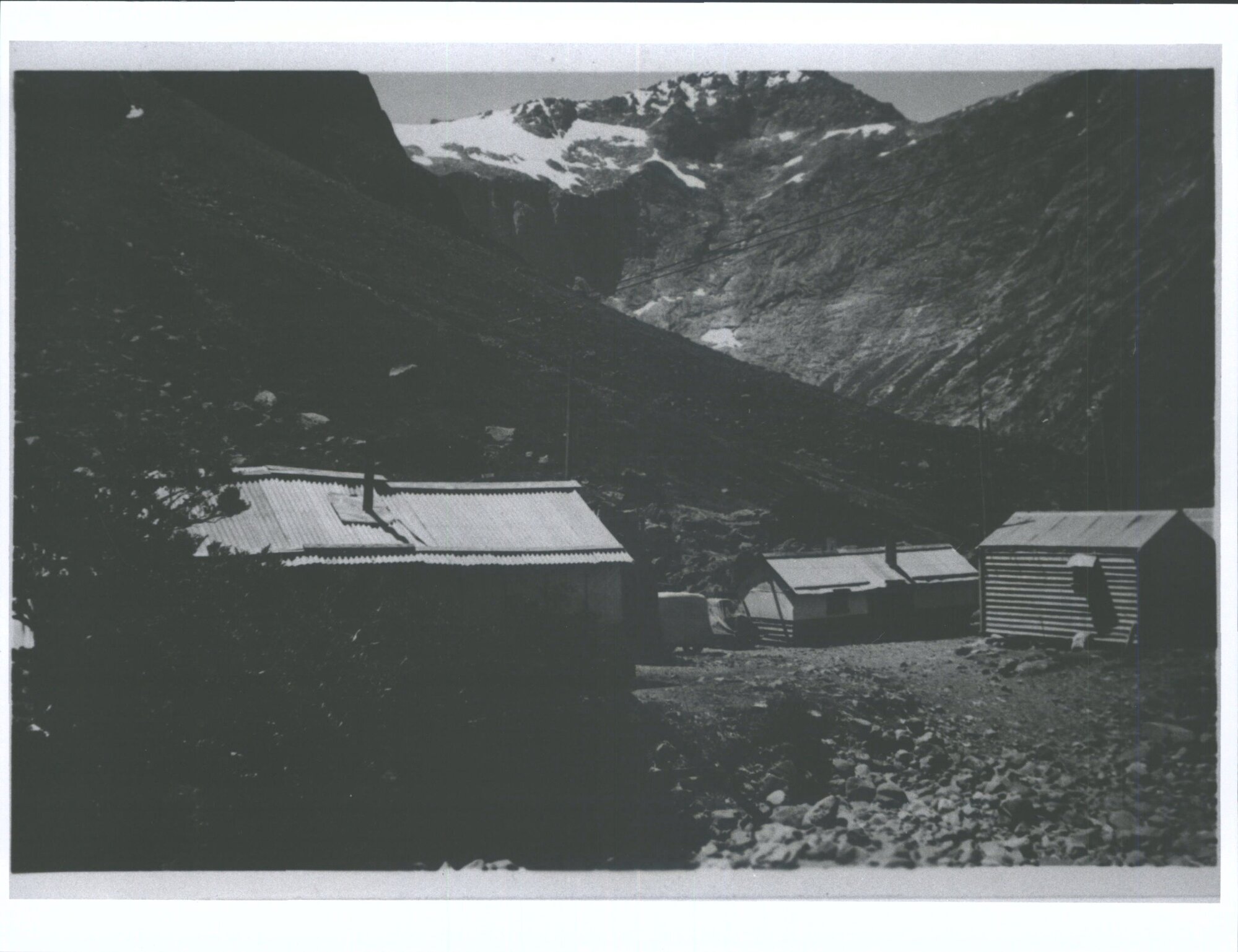 "Part of Homer Tunnel camp. In background Mt Barrion &amp; cirque at the head of Hollyford Valley"
