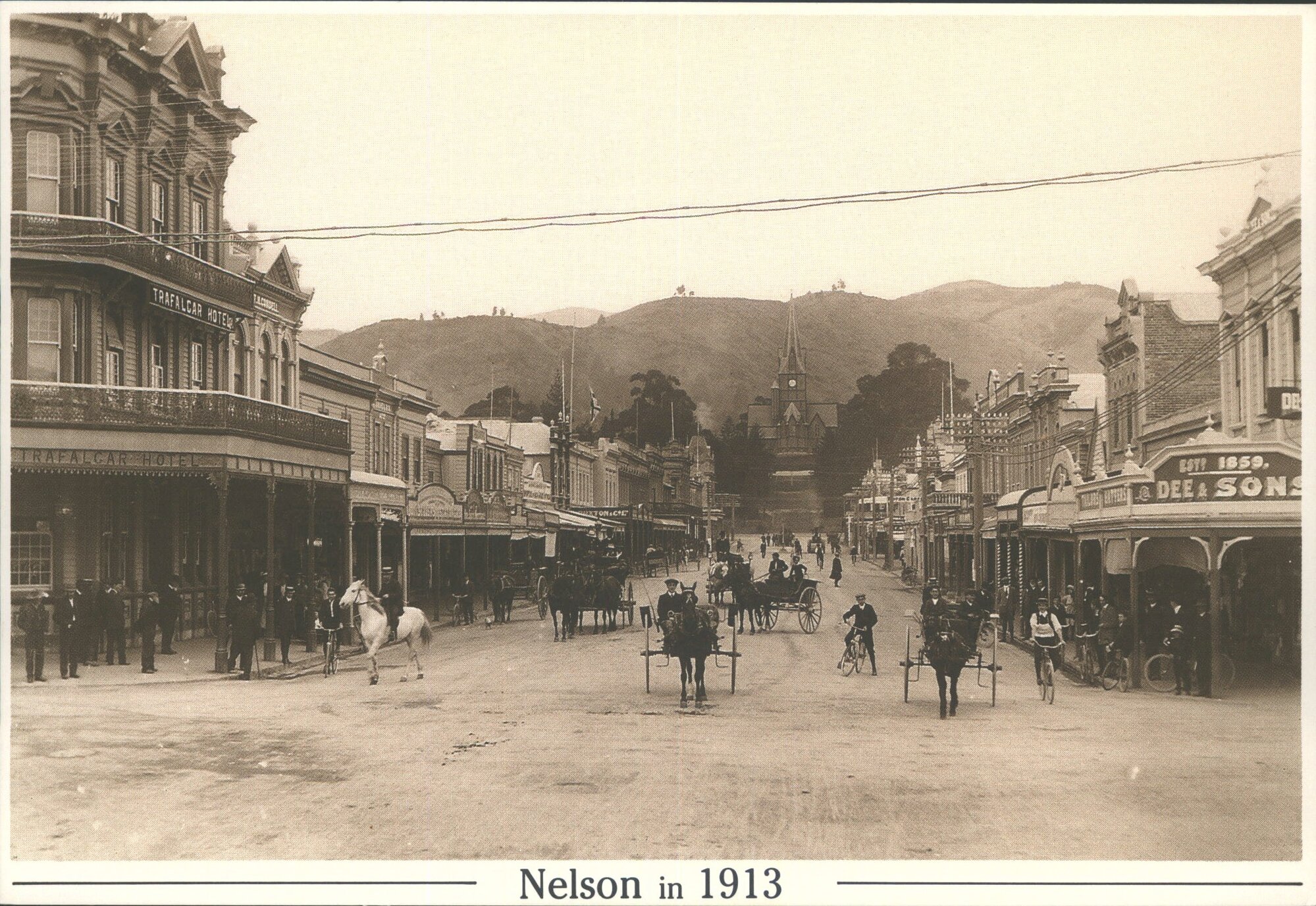 Trafalgar St, Nelson NZ, in 1913, looking south from the intersection with Bridge St to the second cathedral.