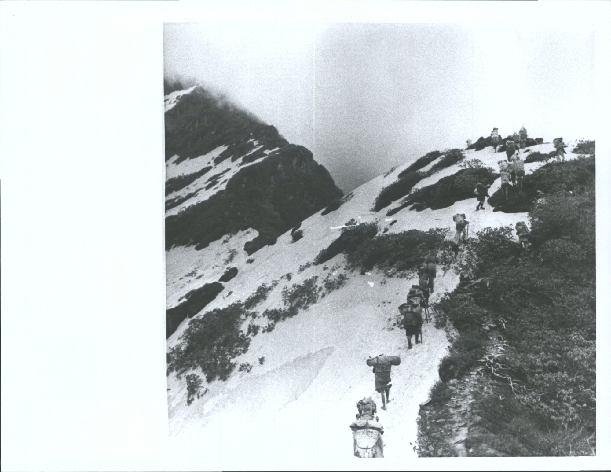 "Carrying out their plans to cross into the Barun by a 14,000 ft pass over the ridge between the Iswa and the Barun, the heavily