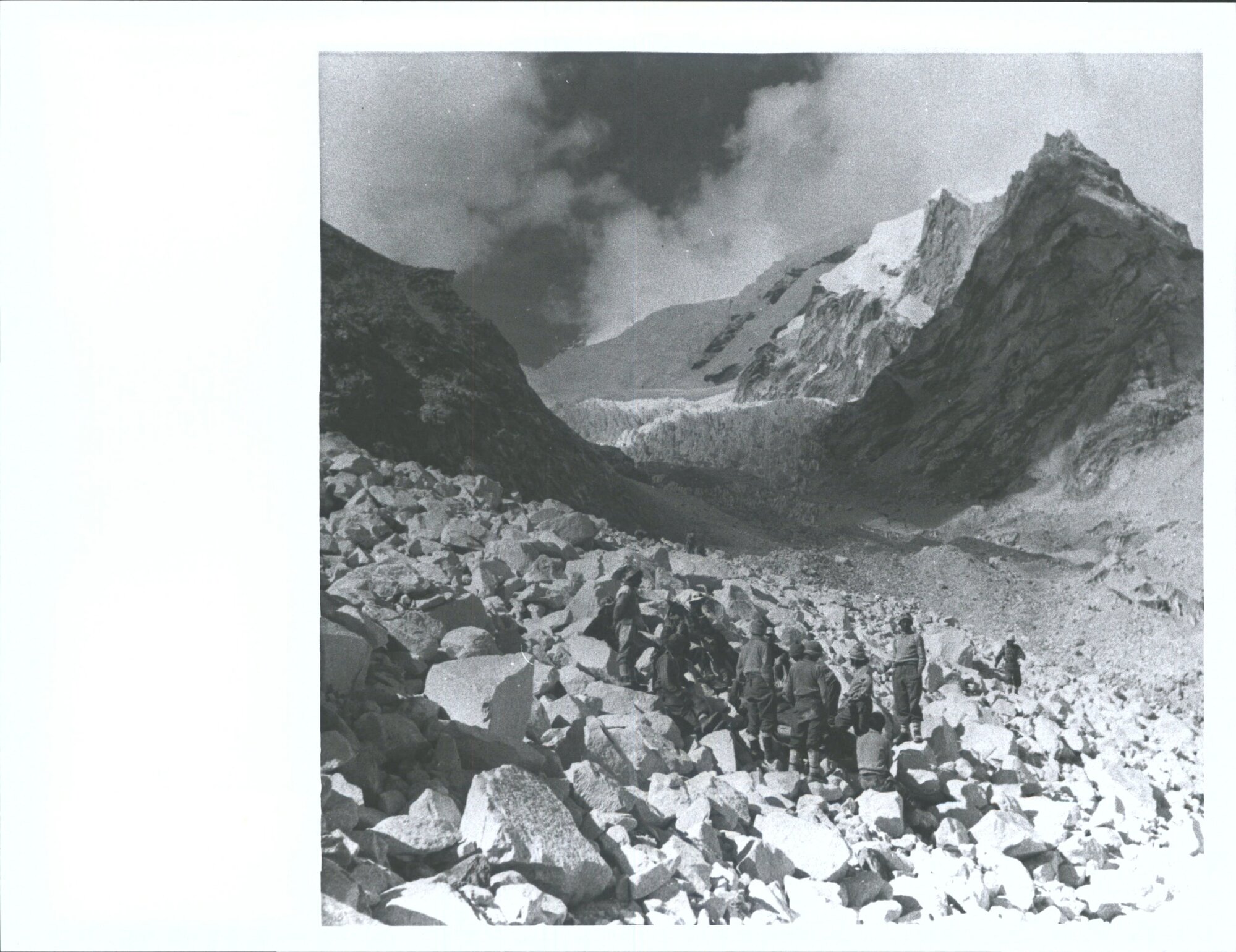 "Hard going on the journey back, Members of the Himalayan Expedition carrying Sir Edmund Hillary on a stretcher over rough bould