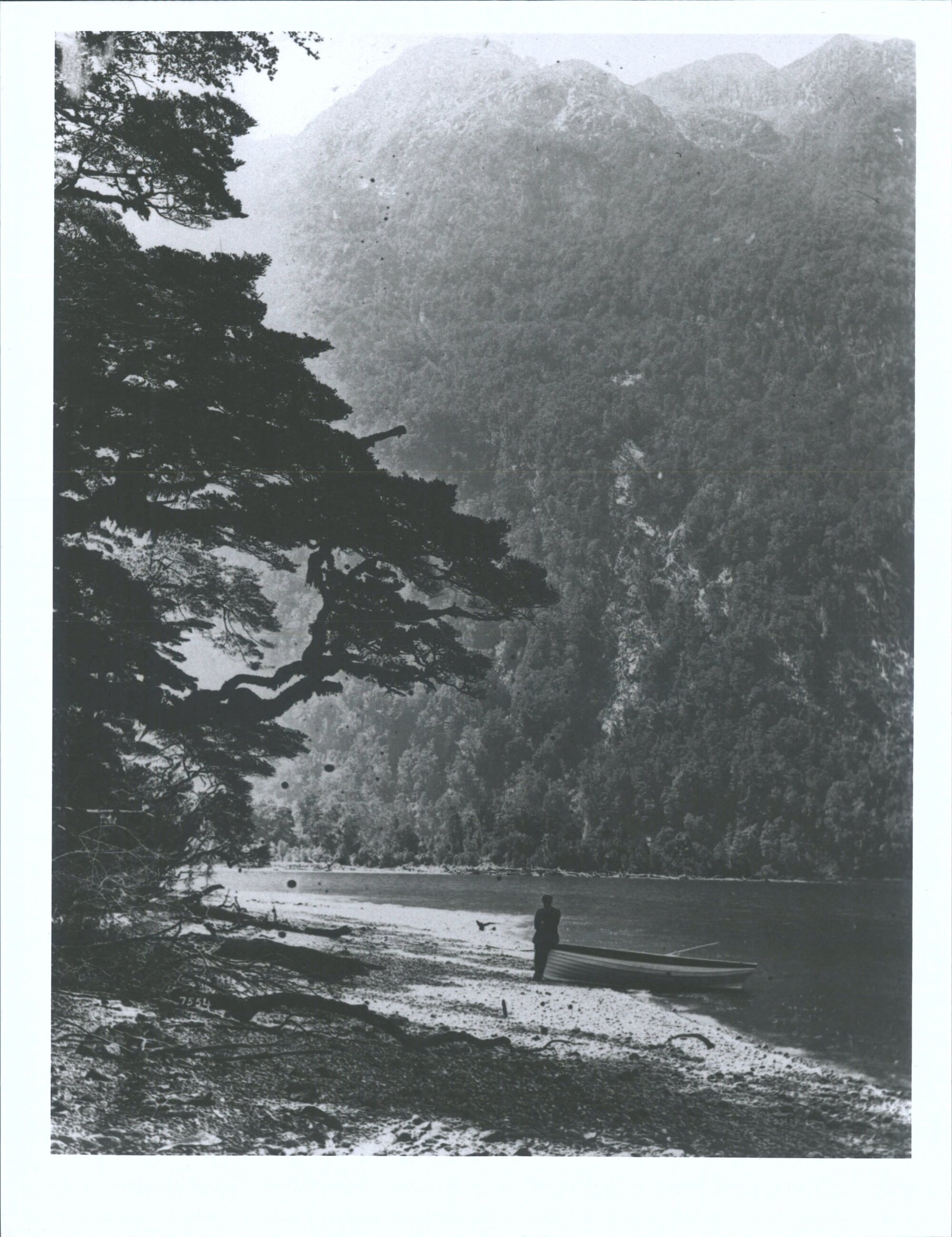 Unidentified man leaning on boat next to Lake Te Anau