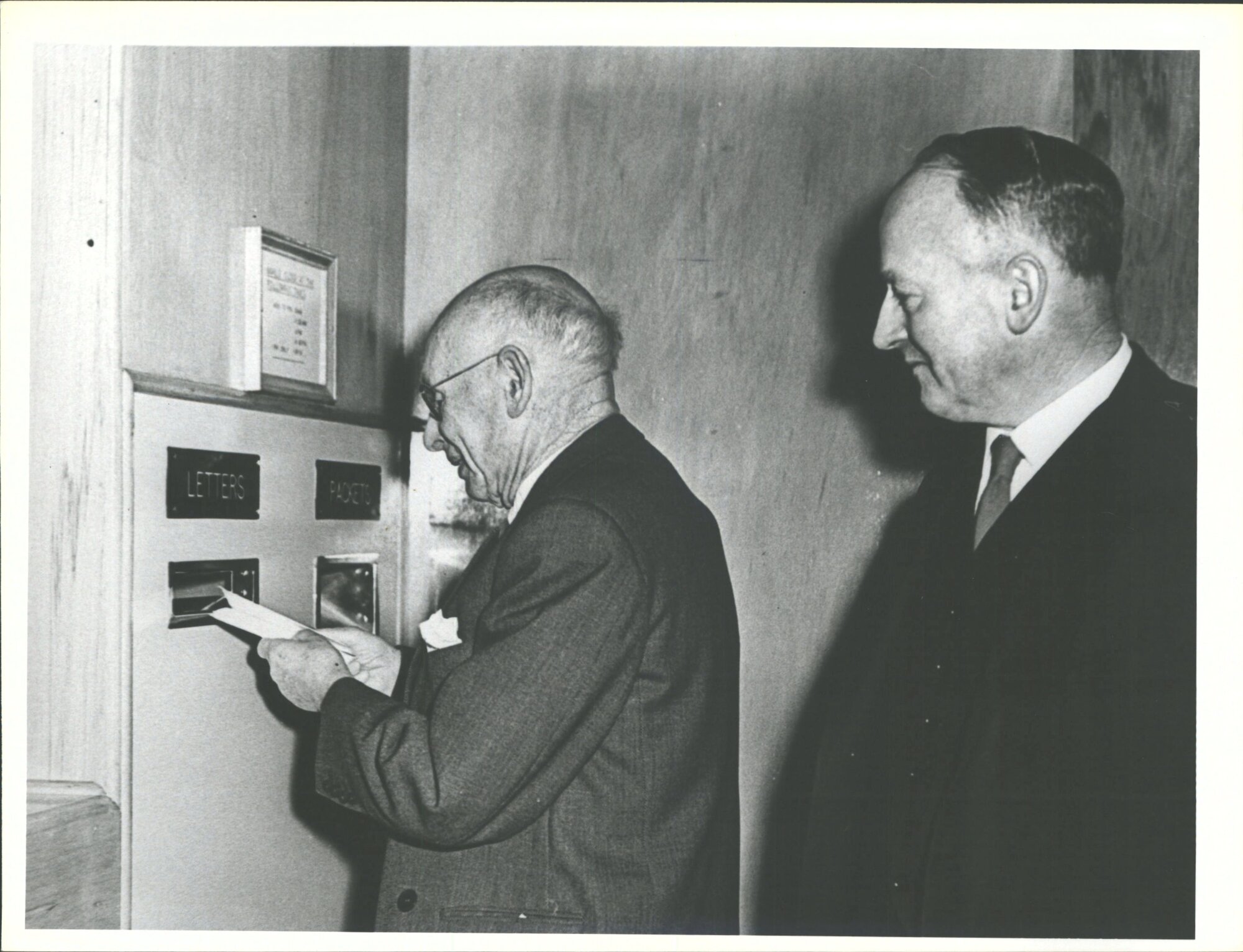 Mr Arthur Barnett posting first letter in Arthur Barnett's Ltd. Post Office with Mr Ted Kerr, Chief Postmaster.