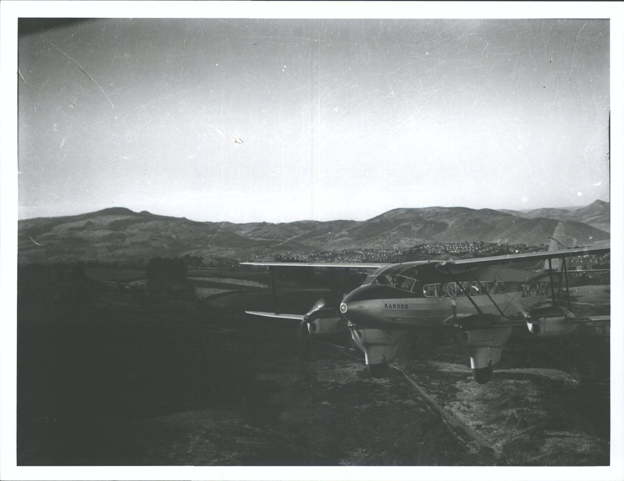 De Havilland D.H.86 "Karoro" in flight over Dunedin