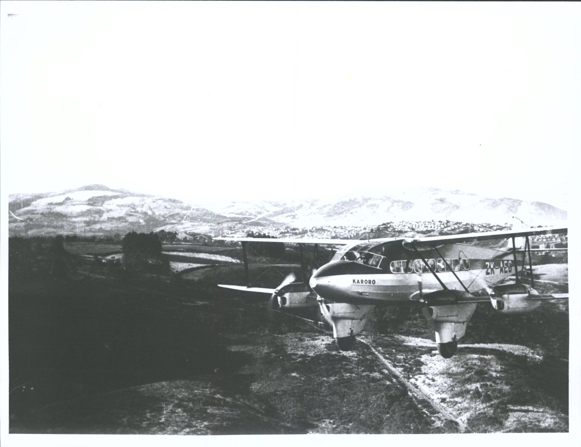 De Havilland D.H.86 "Karoro" in flight over Dunedin