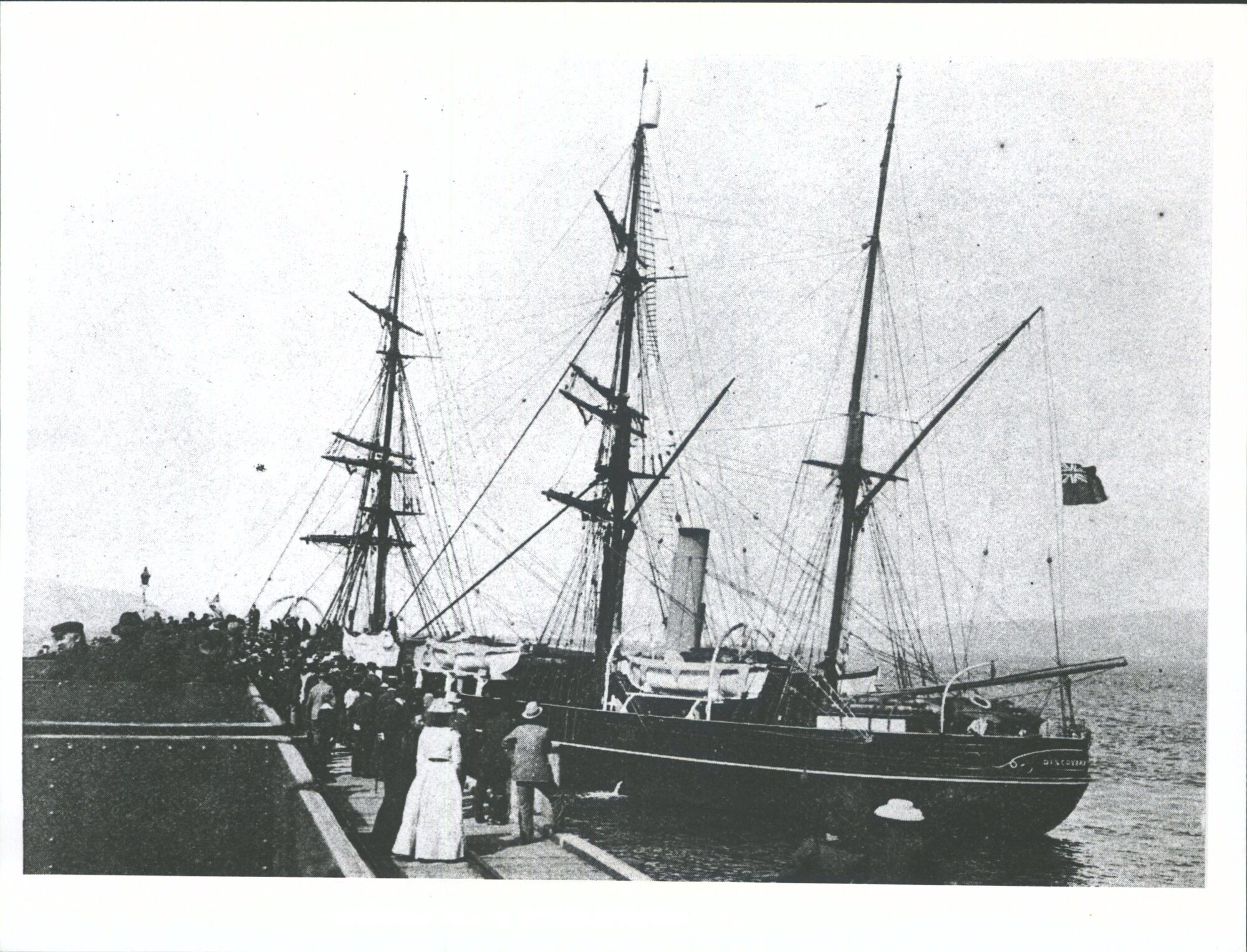 Antarctic Steamer Discovery coming alongside the wharf at Port Chalmers -showing  the Blue Ensign at half mast  'high"
