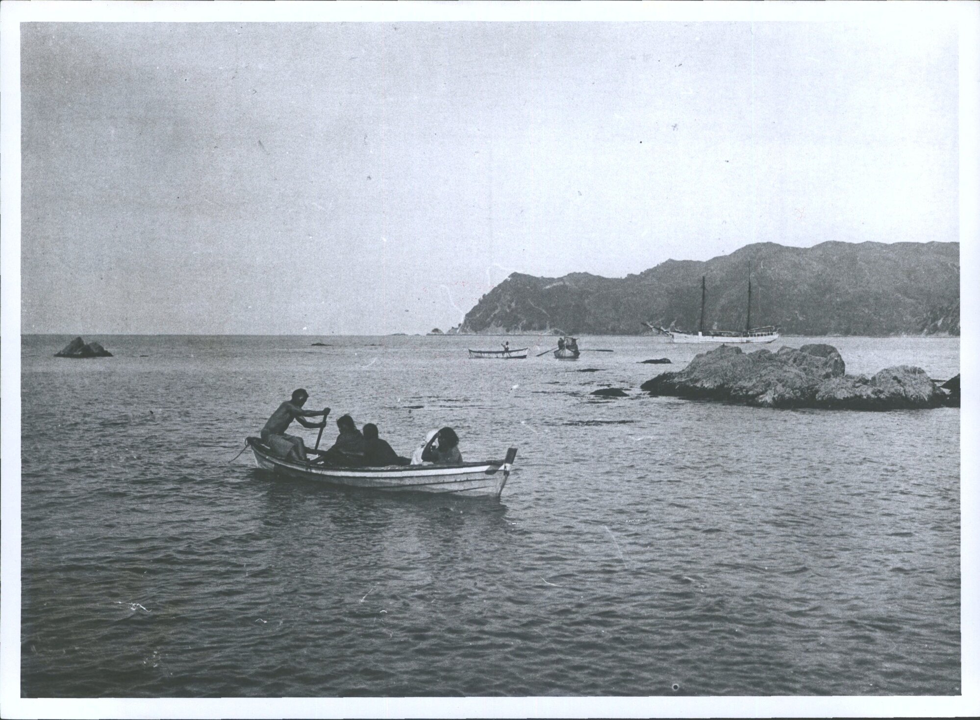 3 canoes and a ship in Waipiro Bay