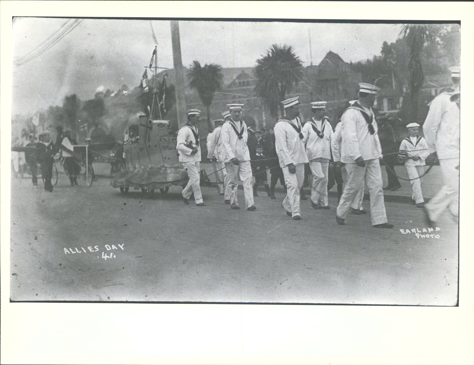 Boy in group in costume with collection box