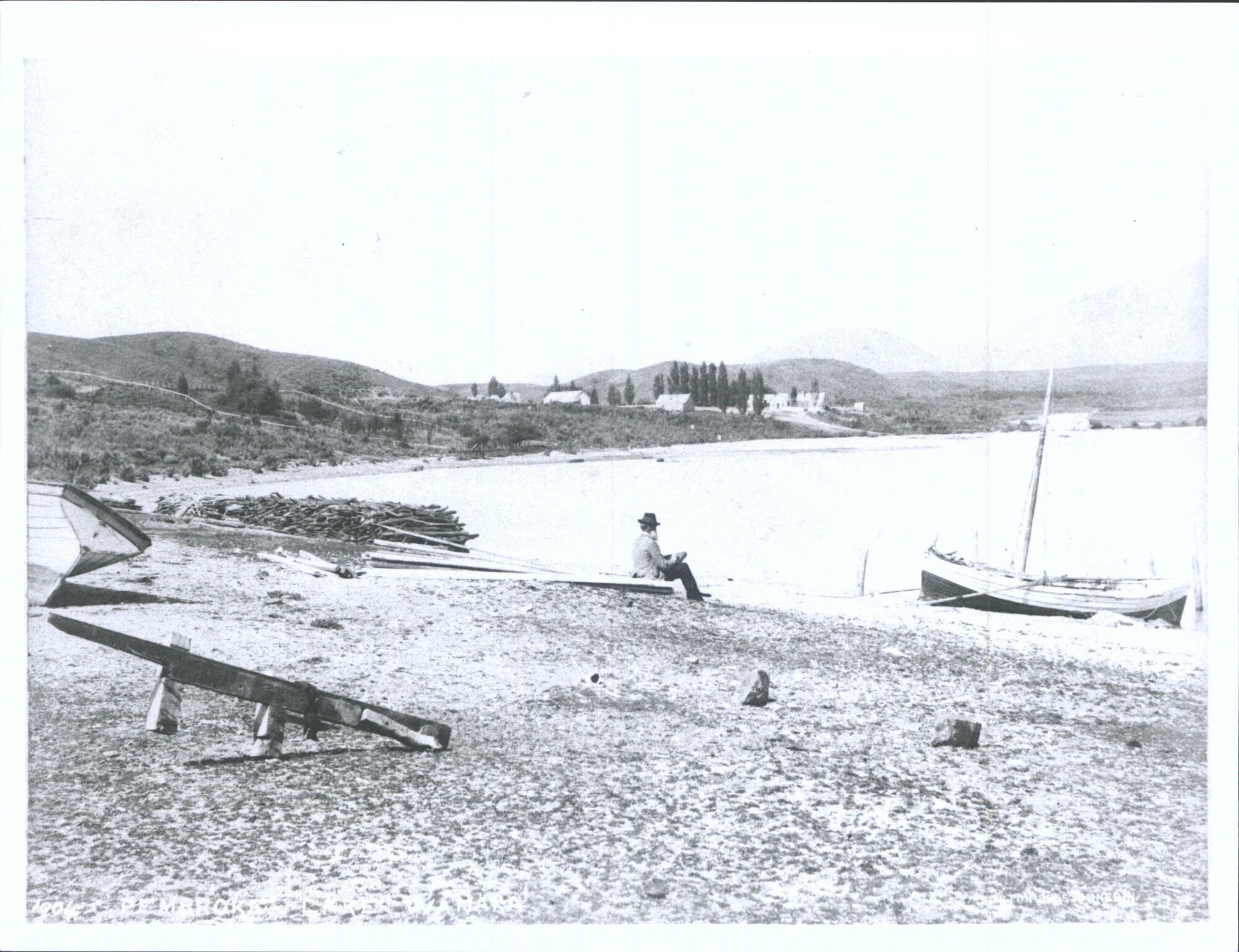 Man sitting on beach, Pembroke, Lake Wanaka