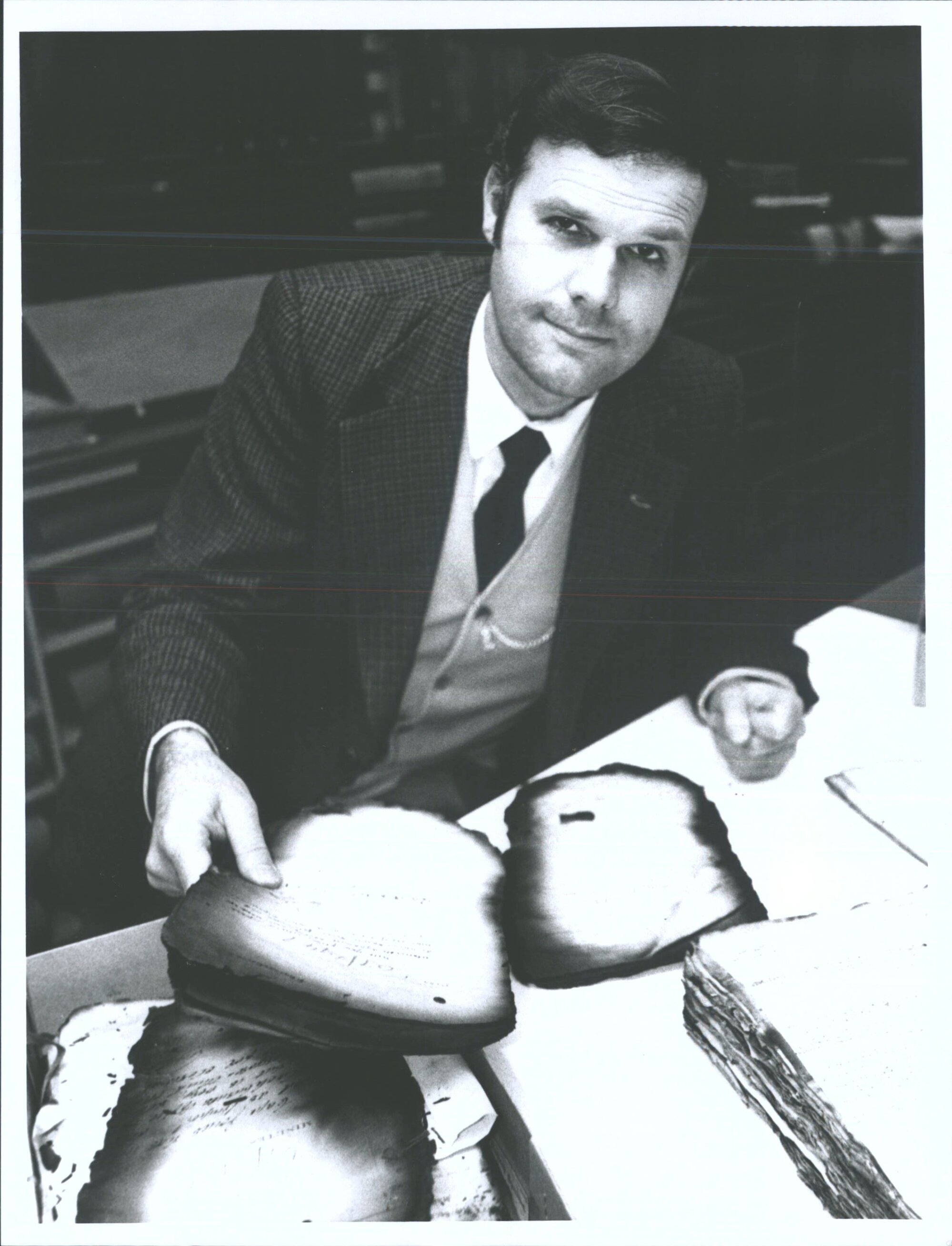 Wayne Nelson of National Archives examines files scorched in the 1952 Hope Gibbons fire