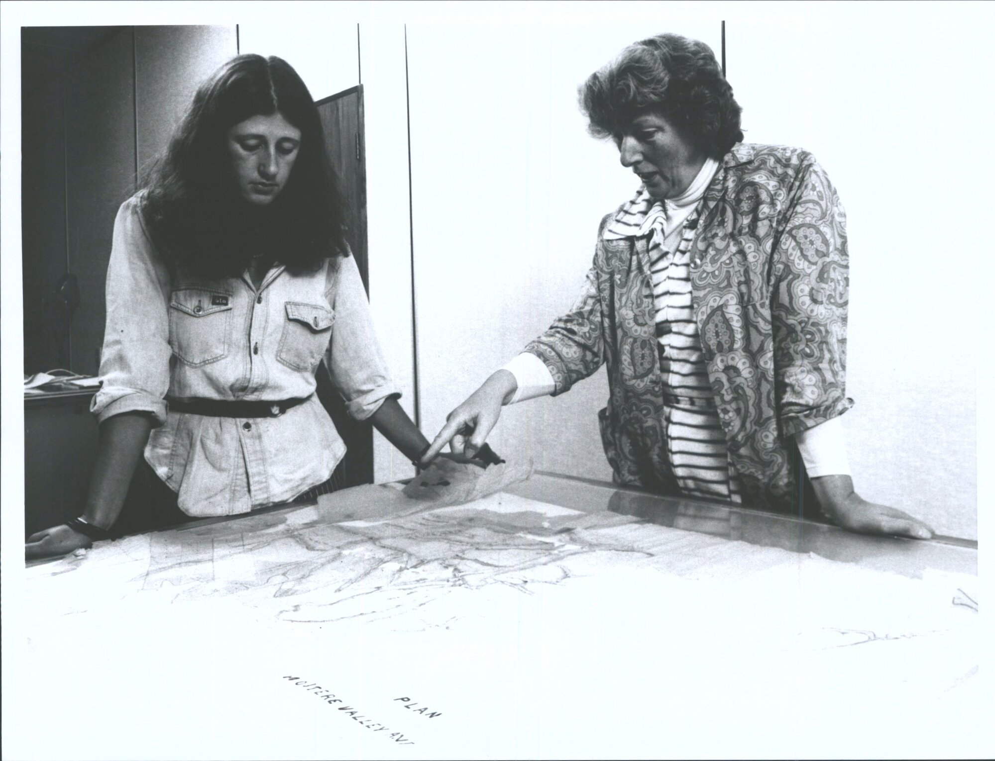 Mrs. Park, Conservation Officer, National Archives discusses conservation of a map with a temporary employee