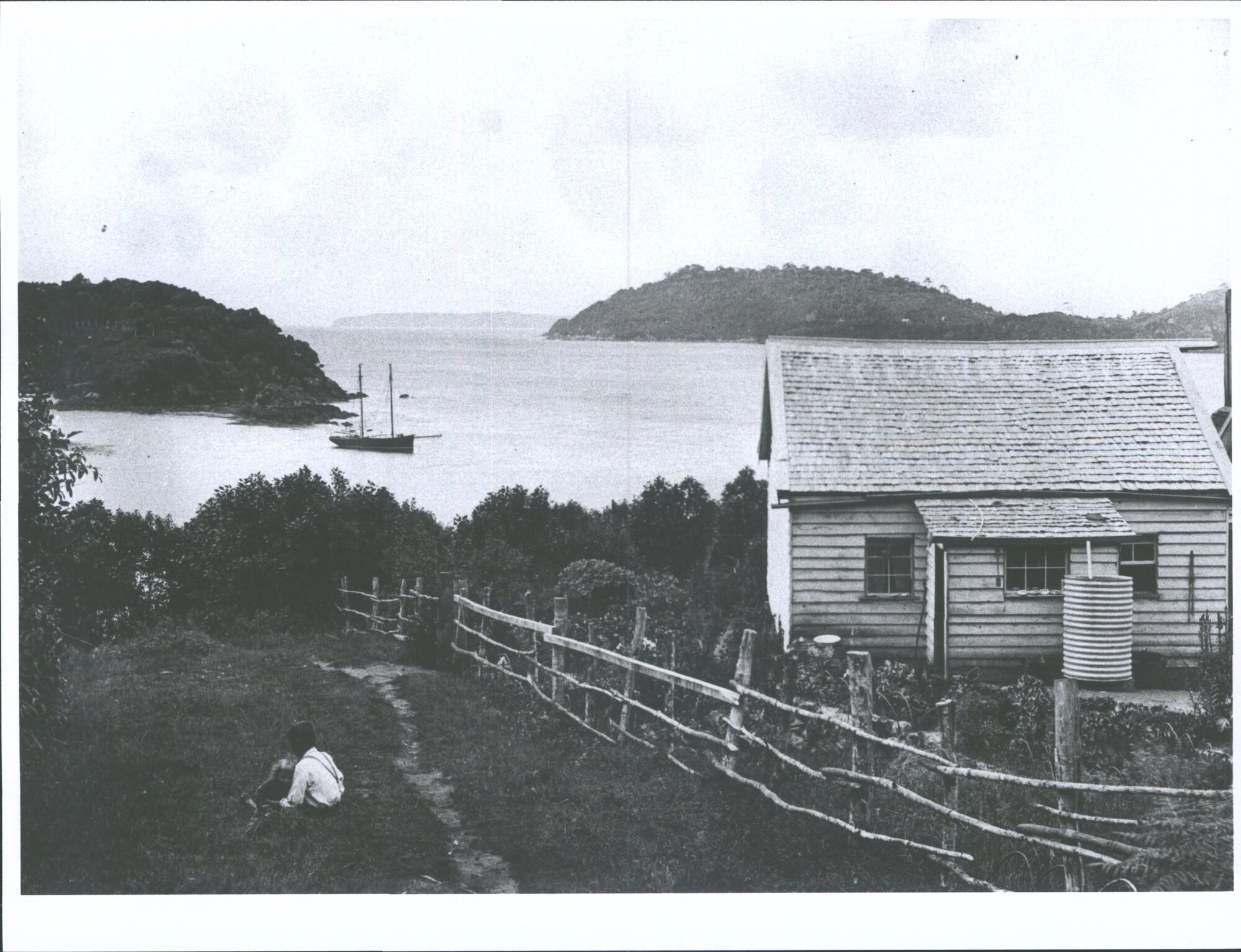 Children sitting outside unknown dwelling