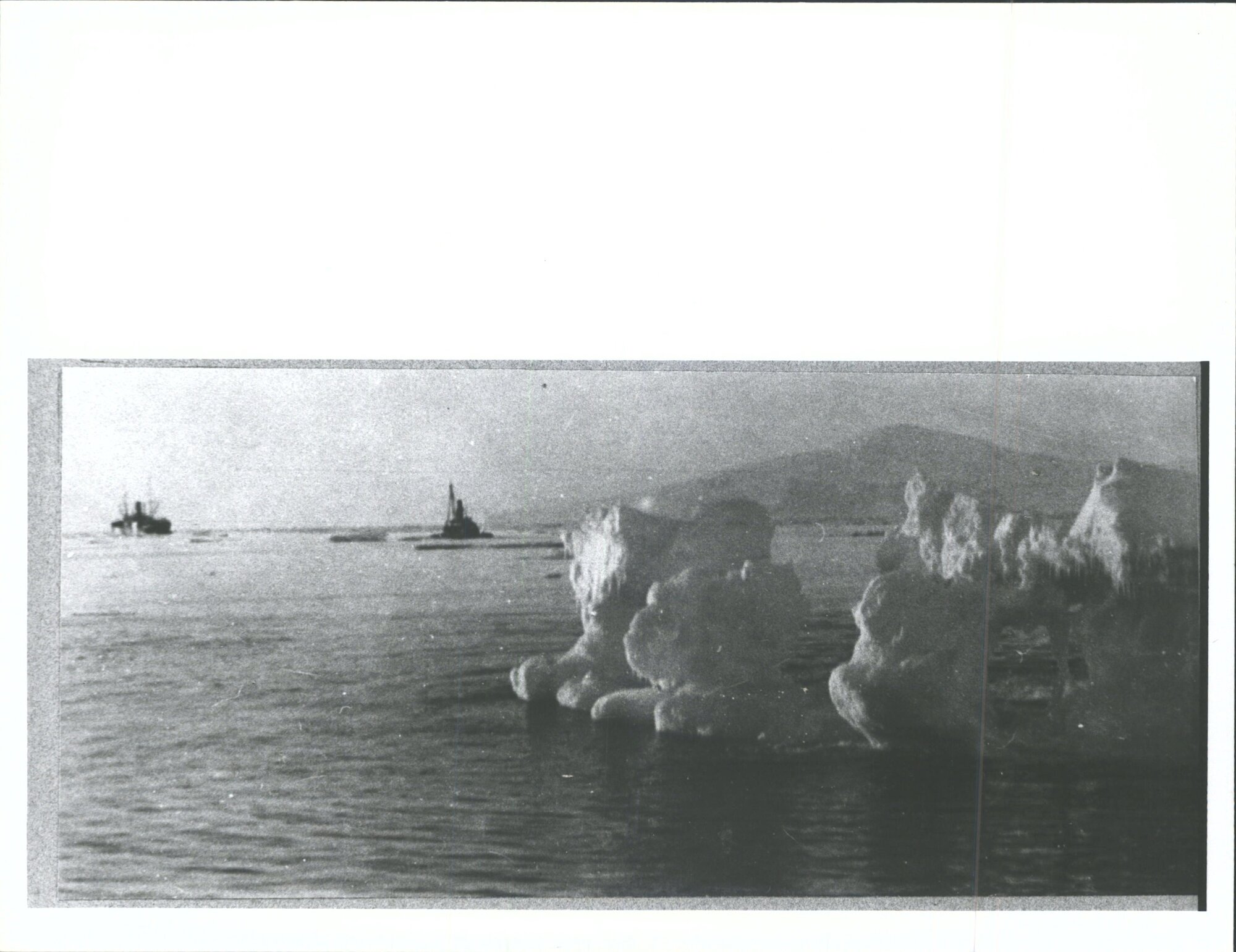 Iceberg and ships in the distance