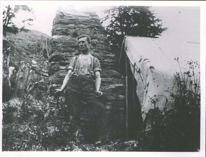 McChesney, T. (miner) outside his sack &amp; canvas hut