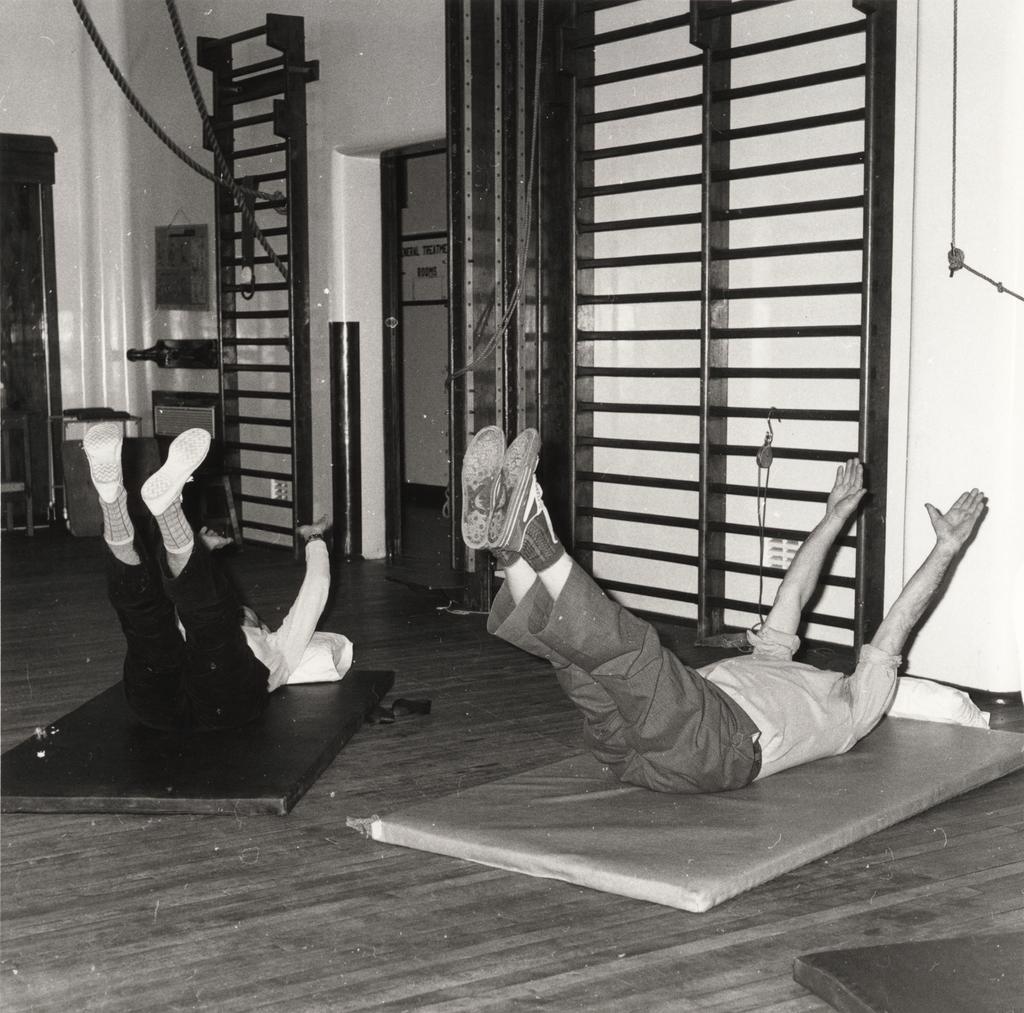 Couple performing leg lift exercises