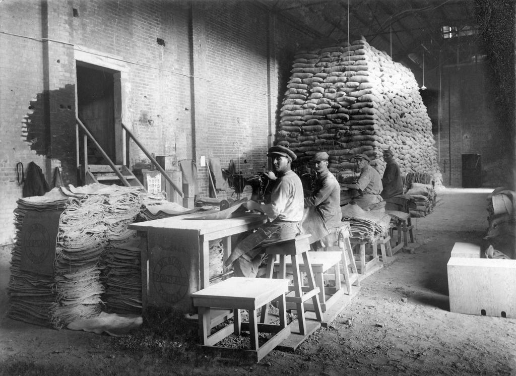 Men sewing sacks at the Milburn Lime and Cement Company works