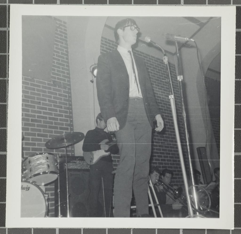 Male vocalist performing with supporting instrumentalists at the 'Folk Proms Concert Capping '67', Union Hall, Dunedin