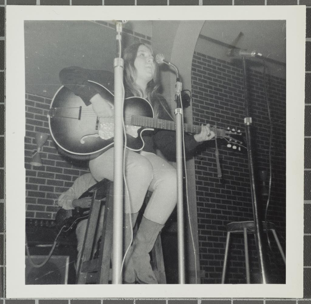 Female vocalist with guitar performing at the 'Folk Proms Concert Capping '67', Union Hall, Dunedin
