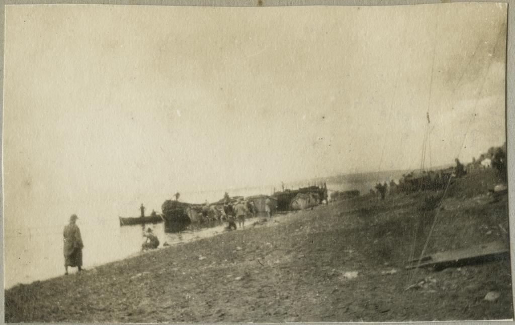 Boats and shore with unidentified human figures