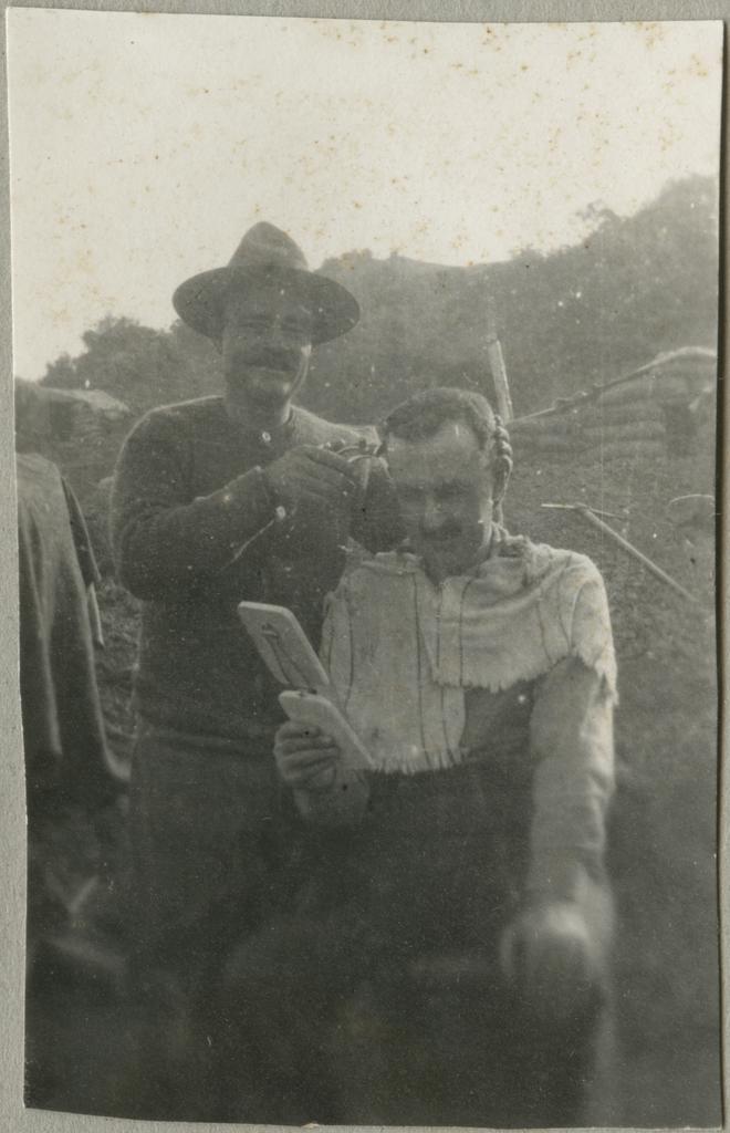 Charles Mackie Begg getting a haircut