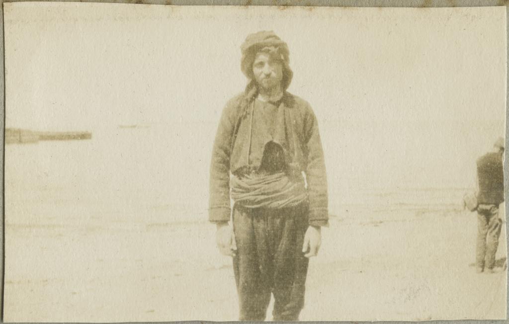 Unidentified man standing on a shore