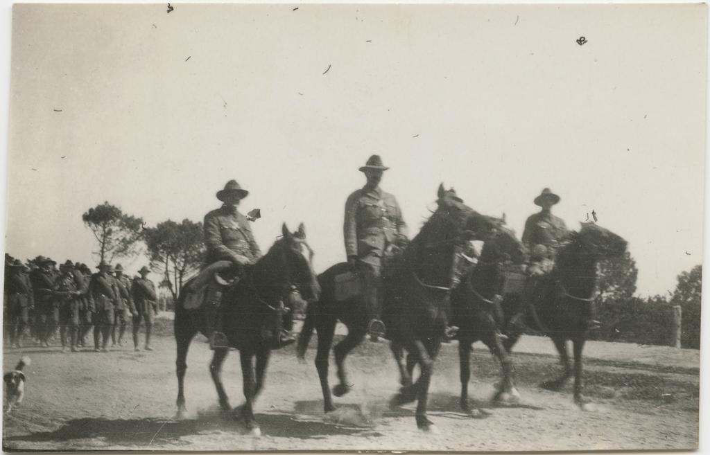 Officers on horseback, with men on foot behind them