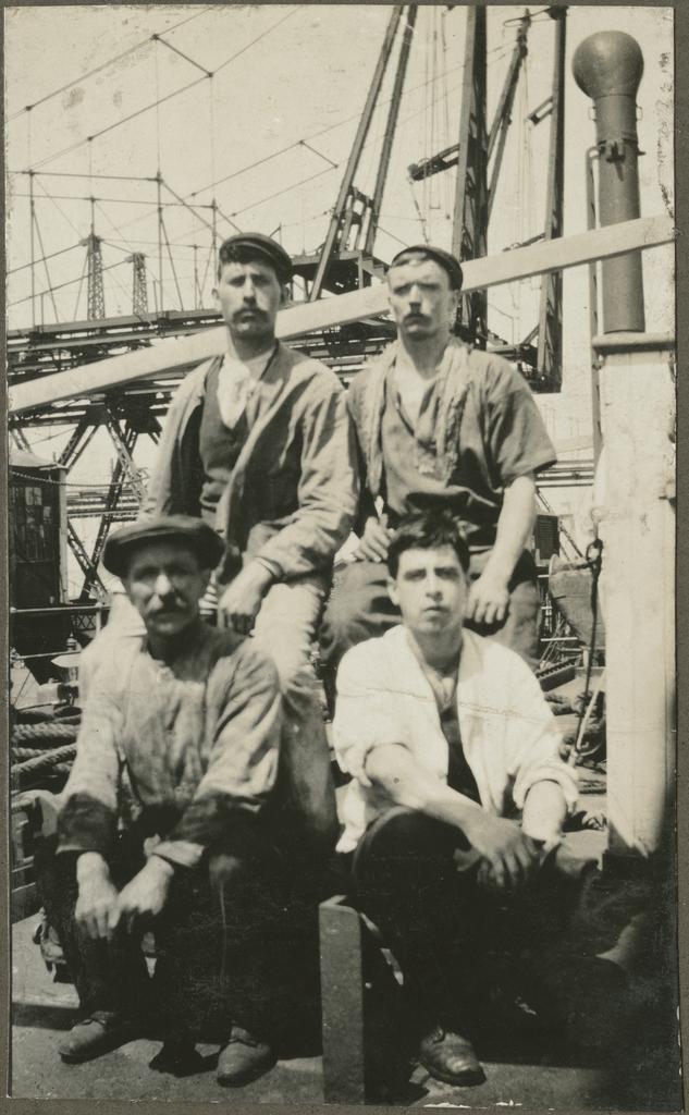 Group of four men on the deck of a ship