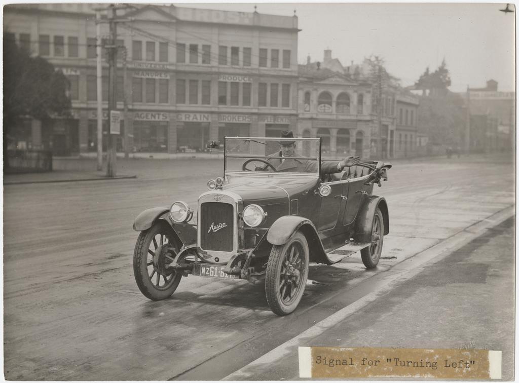 'Signal for turning left', showing motorist on Cumberland Street (at Queens Gardens), Dunedin
