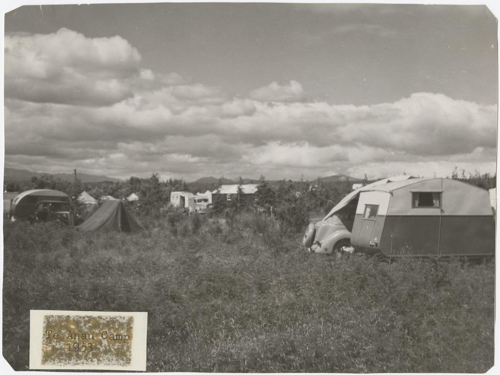 'Te Anau Camp 1953', showing caravans, tents, and cars