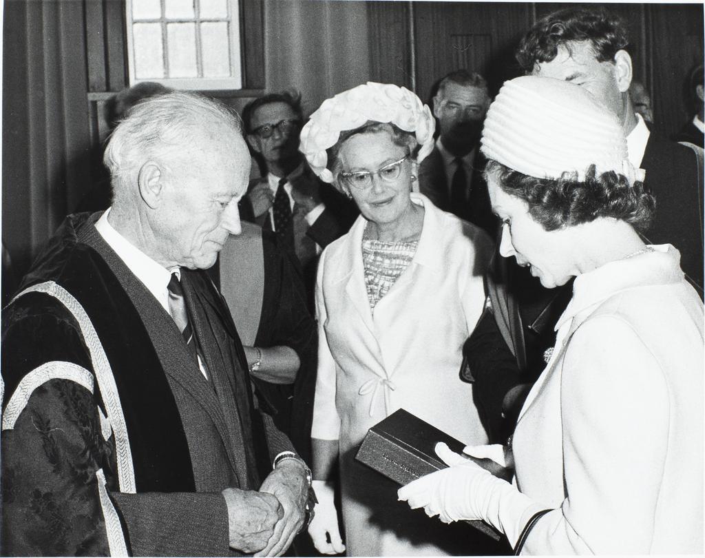 '[University of Otago] Chancellor H.J. Ryburn presenting [Queen Elizabeth II] a copy of the centennial history and centennial record'