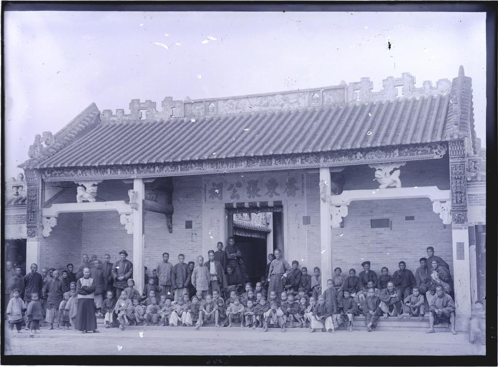 Group on front verandah of a village temple or hall