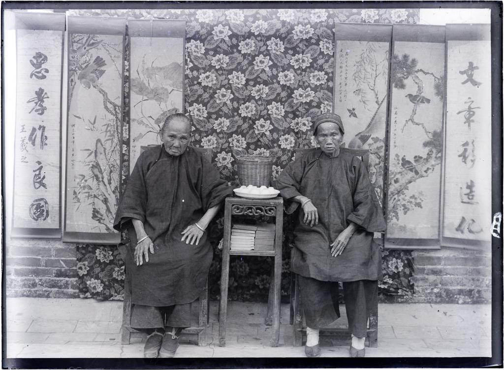 Two elderly Chinese women with tea basket, 'the mothers of the church at Leung Lin'