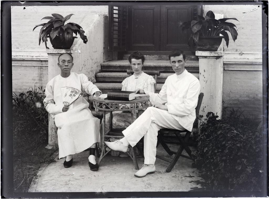 Three people seated around a table