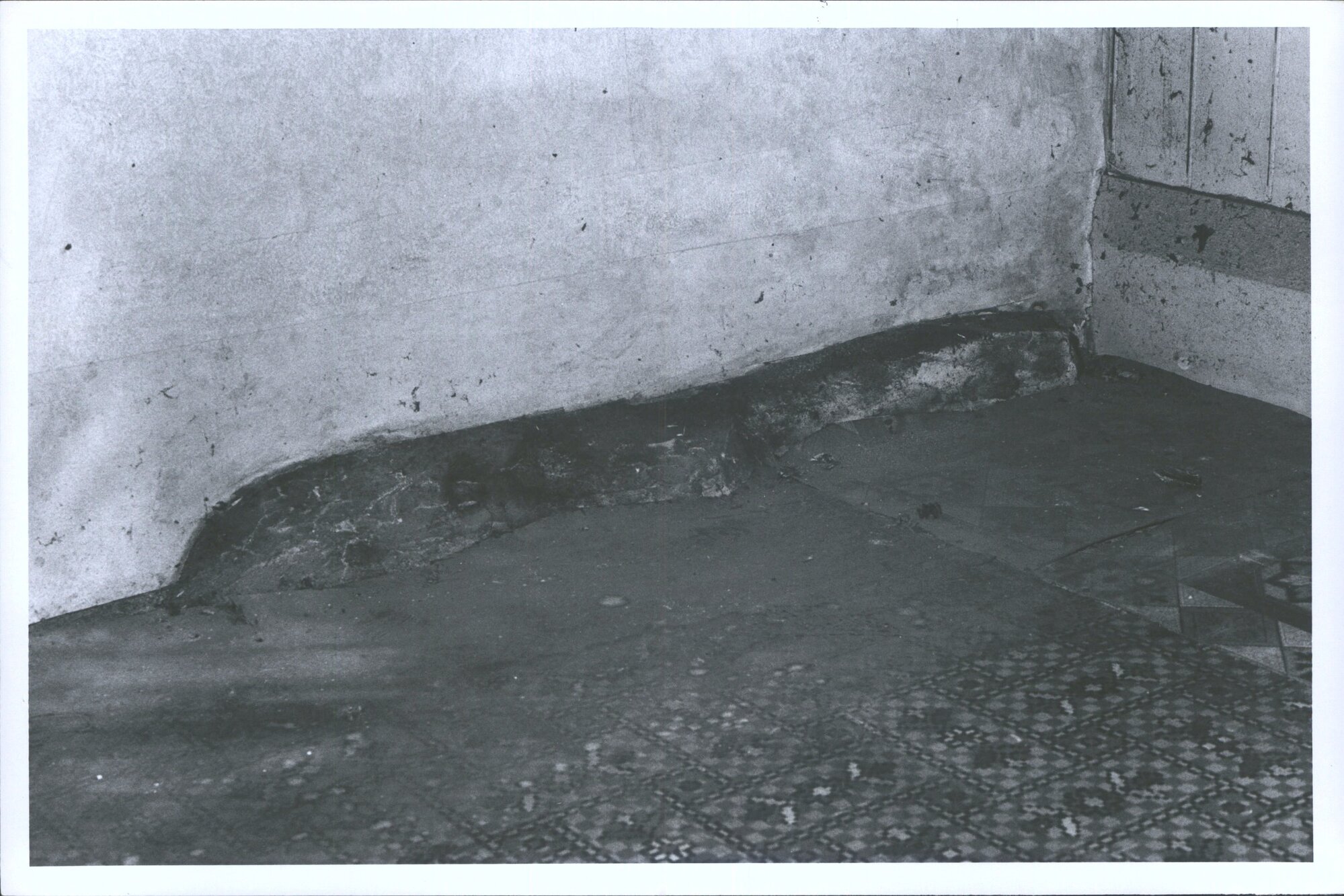 Stone (not blue stone or other hard rock) left in place with brick party wall built over floor boards contoured to shape