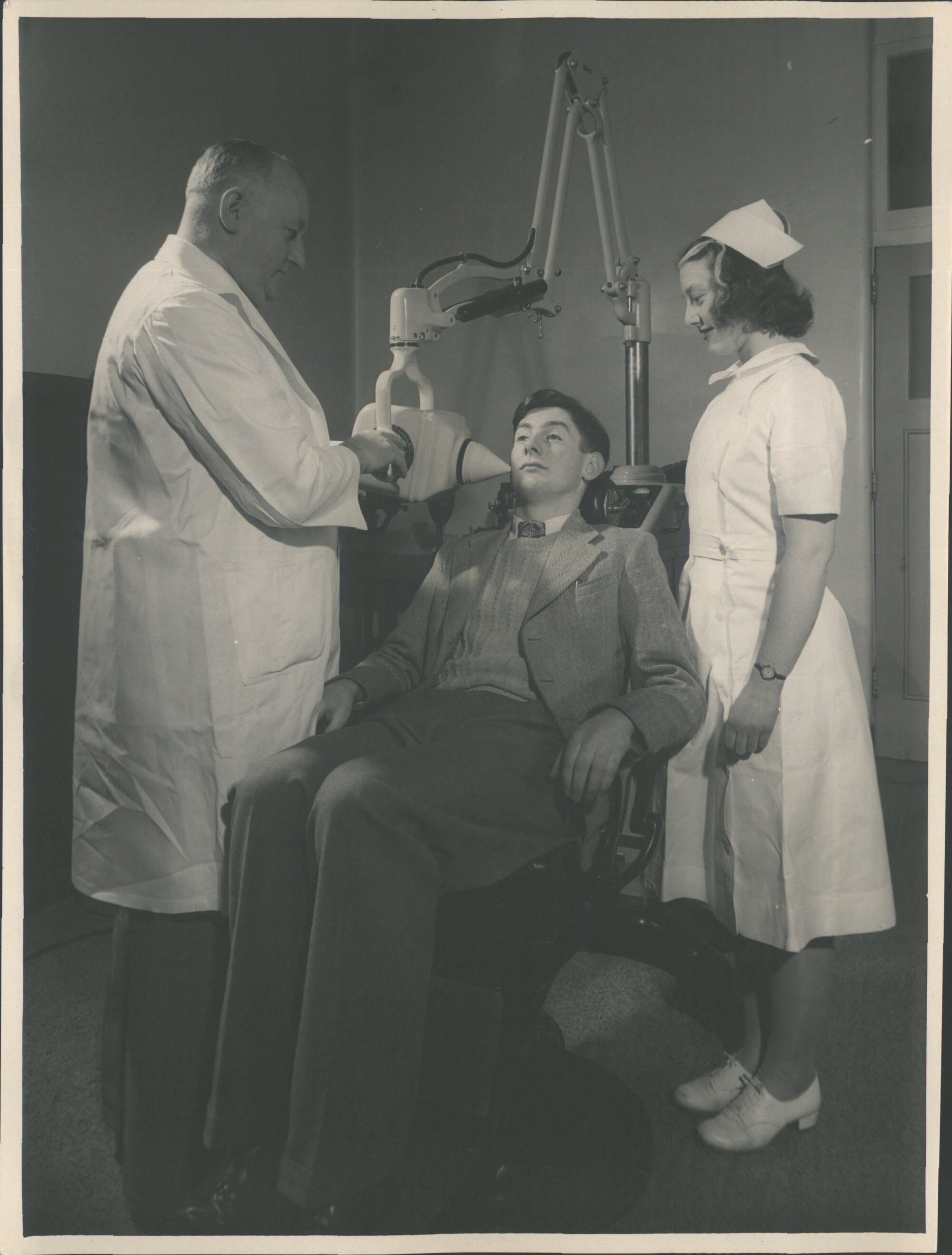 "An X-ray machine in use at the Dental School, Dunedin. Mr. D. A. Mackay, Radiographer, taking a "Bitewing" film of the right si
