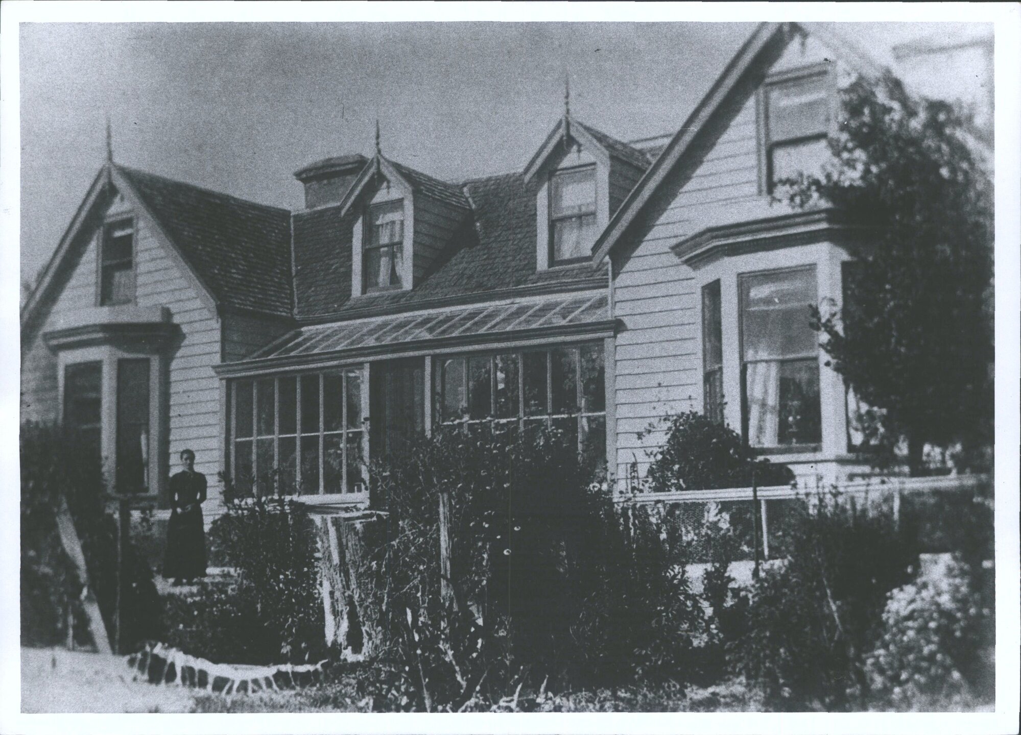 Unidentified Woman standing in front of "The Grange"