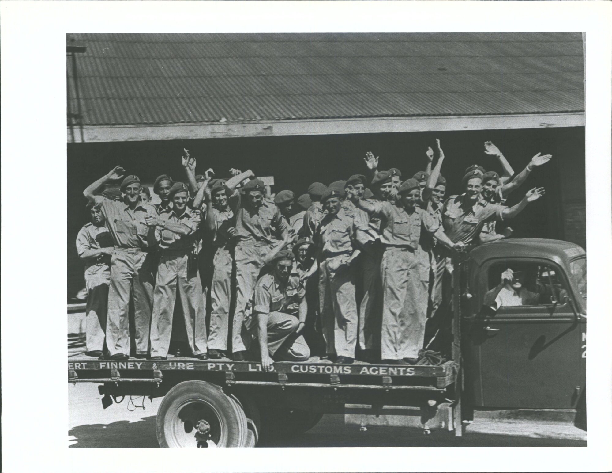 K' Force 'N.Z troops on leave hitchhike to the City on a truck leaving the Wharf