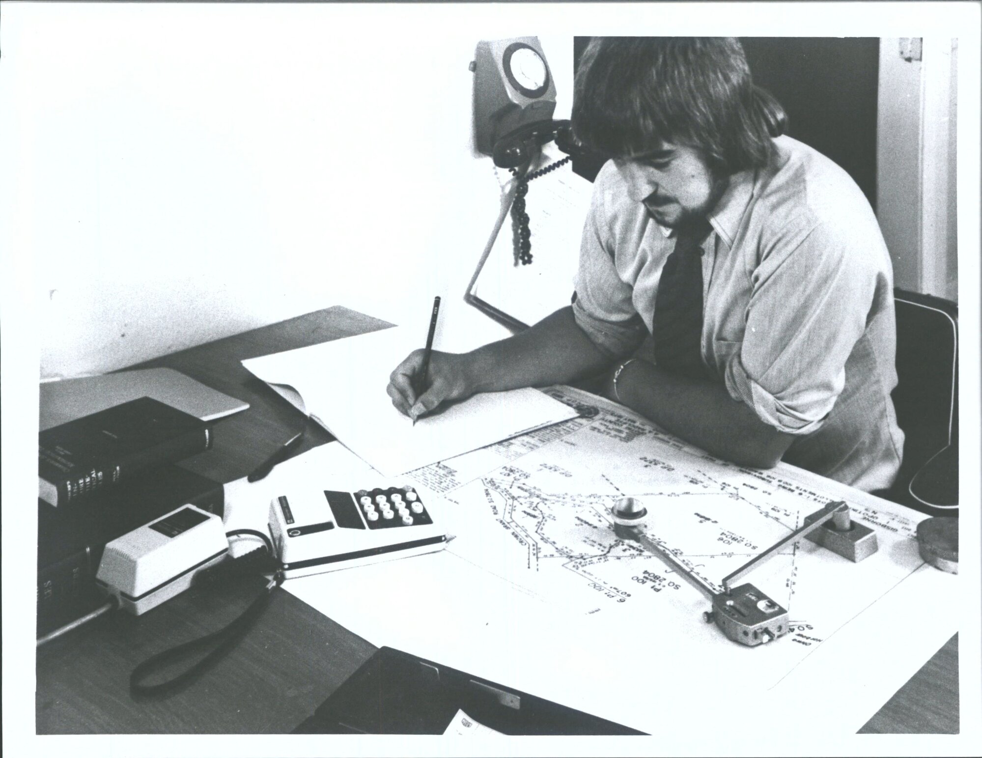 "A Lands   Survey draughtsman calculates plan areas using a planimeter"