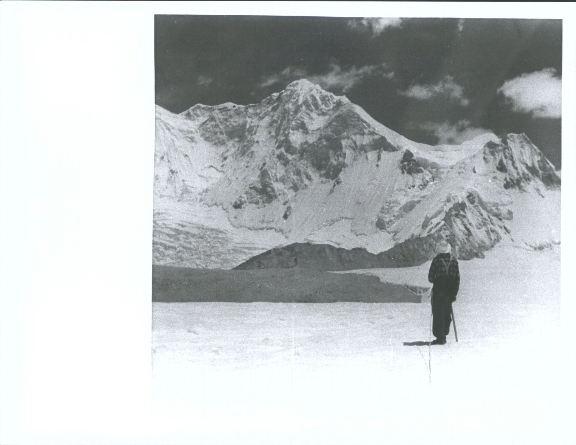 "G. Harrow surveys Baruntse (23,560'). The Summit of Baruntse was reached by the N.Z.H.E. on May 30 after a very difficult passa