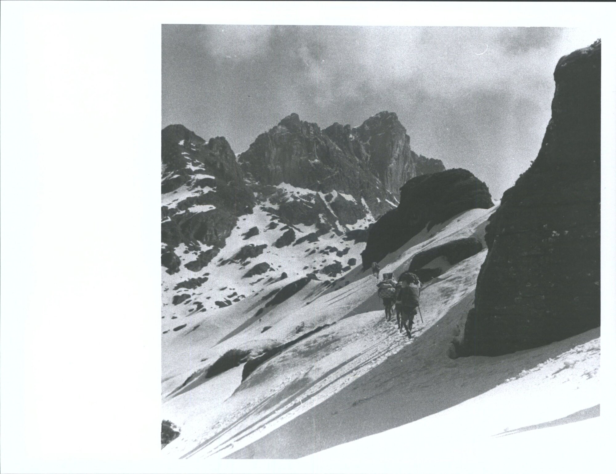 "Climbing up to the base camp at 15,500 ft, the expedition moves up the pass to the Barun. High above on both sides are tremendo
