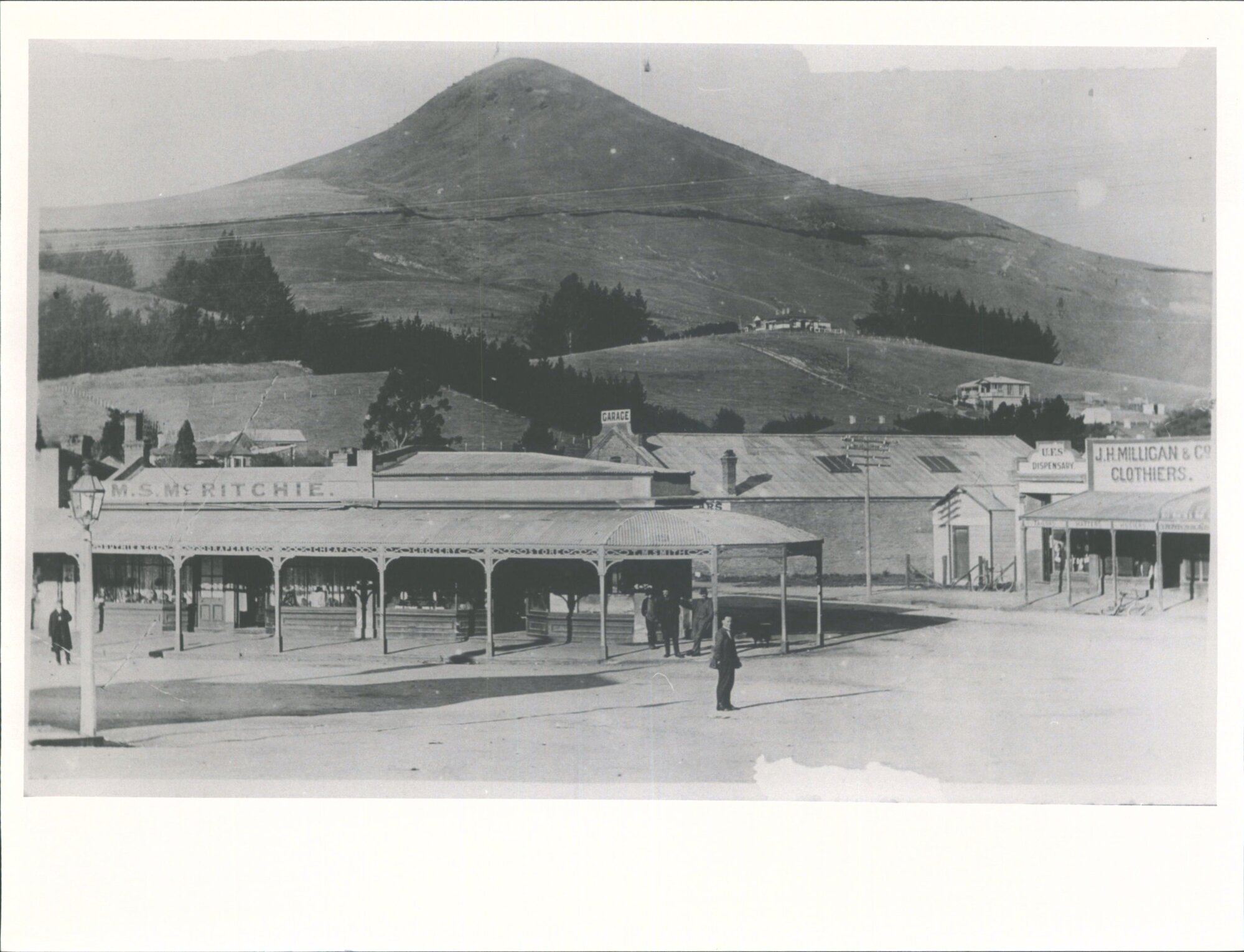 Street scene showing the business premises of M.S. McRitchie and J.H. Milligan &amp; Co.
