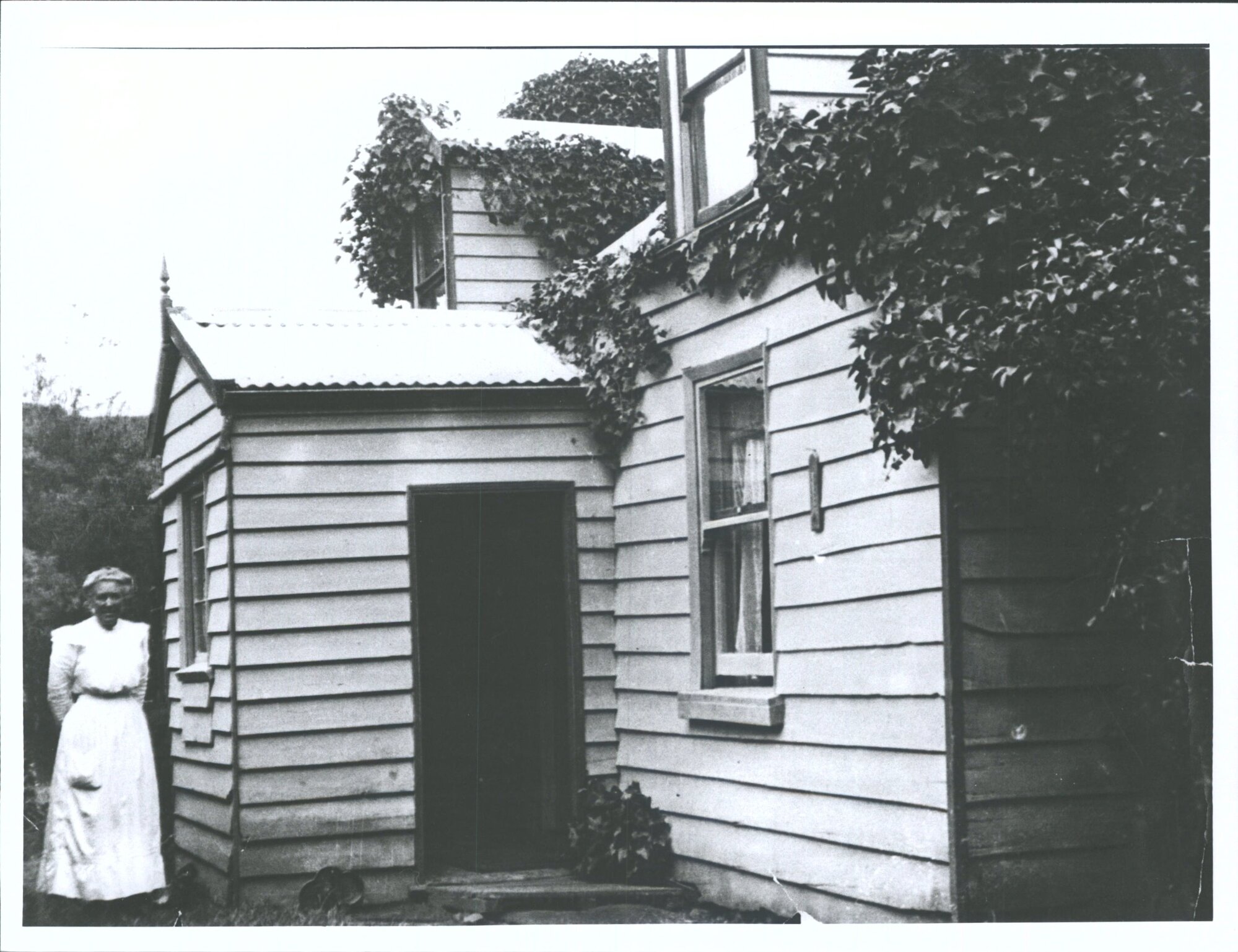 Miss Mitchell outside house