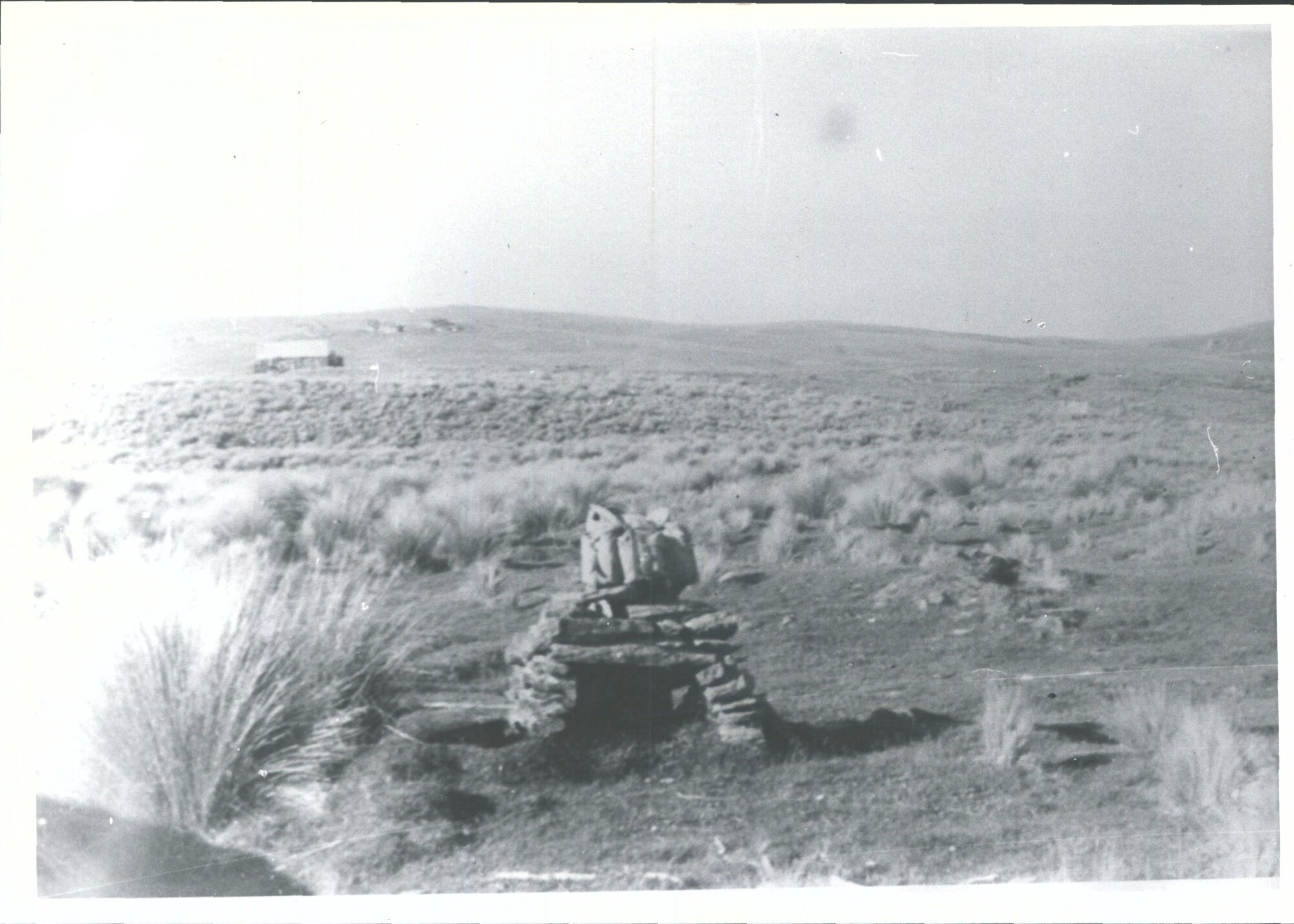 Fireplace with old hut in background
