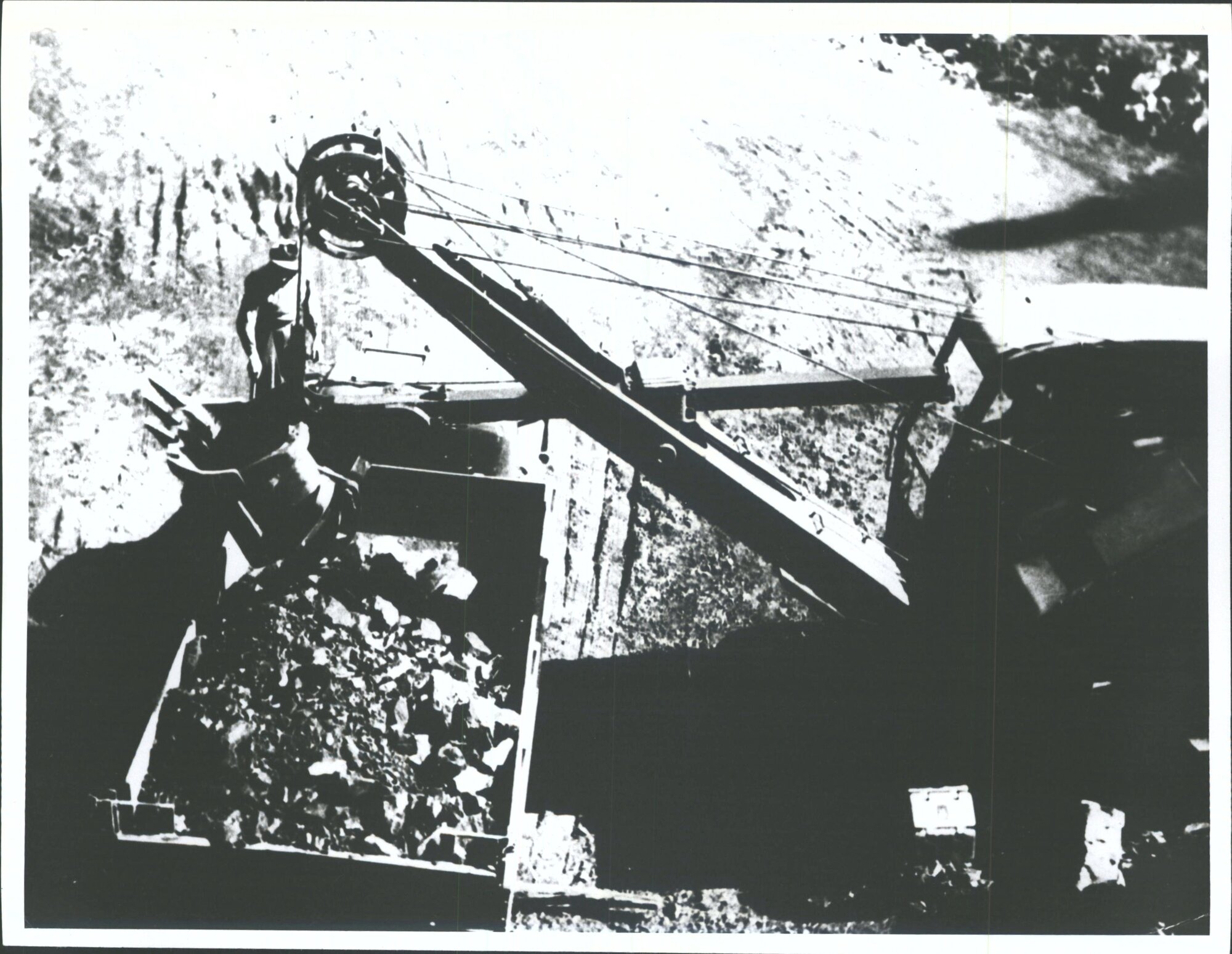 Excavator unloading into truck